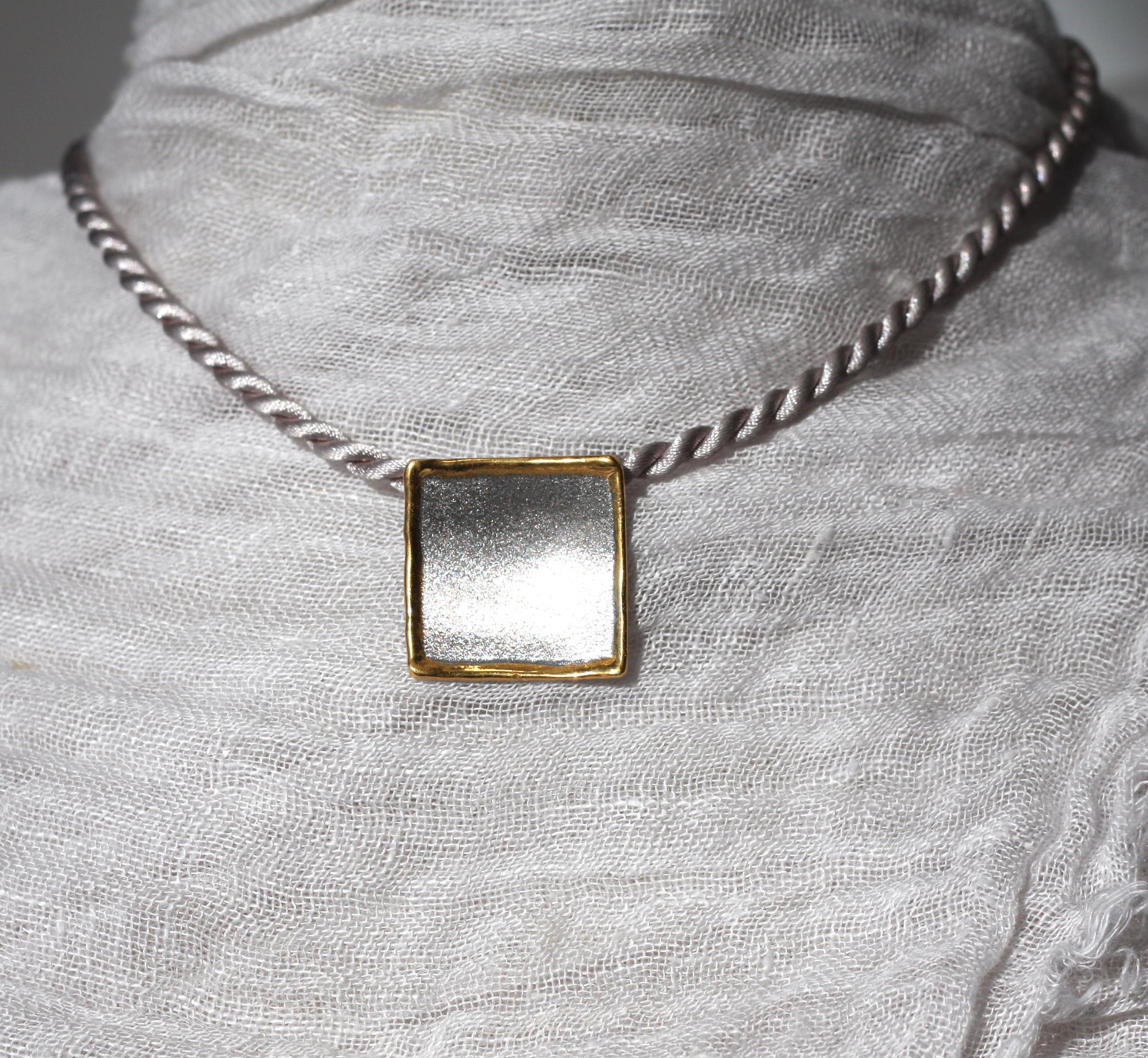 Yianni Creations geometrically shaped pendant enhancer from Midas Collection, which is all handcrafted from fine silver 950 purity and plated with palladium to resist the elements. This beautiful artisan pendant in its purity attracts by its texture