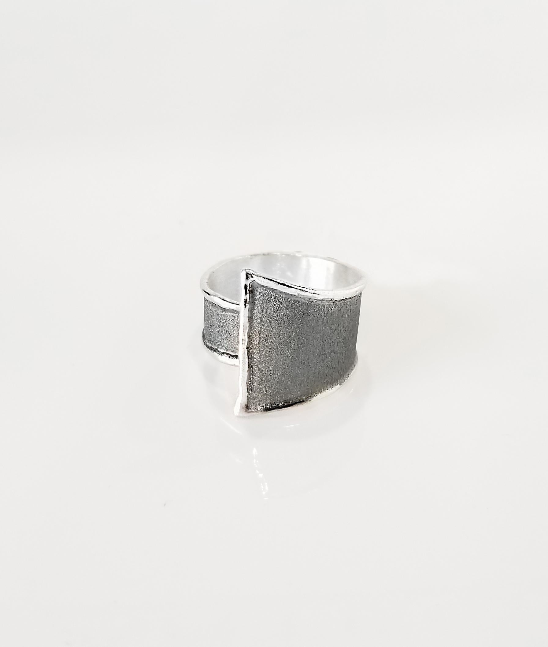 Yianni Creations Hephestos Collection 100% Handmade Artisan Ring from Fine Silver. The ring features a unique oxidized Rhodium finish complemented by unique techniques of craftsmanship - brushed texture and nature-inspired liquid edges. The core of