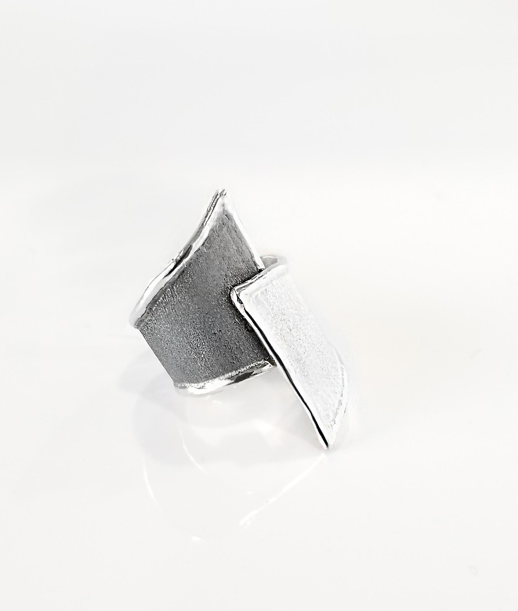 Yianni Creations Hephestos Collection 100% Handmade Artisan Ring from Fine Silver. The ring features unique oxidized Rhodium background in contrast with the white opposite. The ring presents unique techniques of craftsmanship - brushed texture and