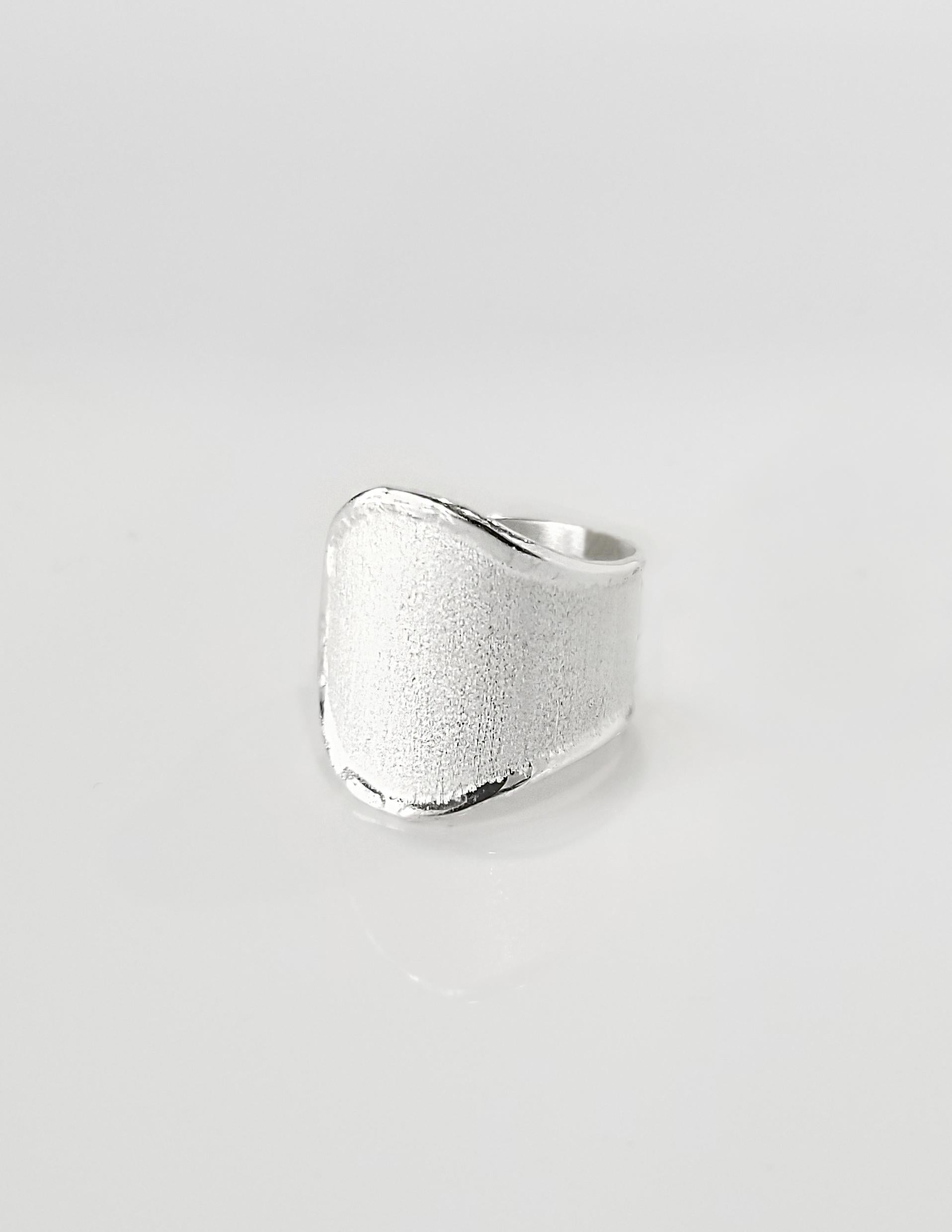 Yianni Creations Ammos Collection 100% Handmade Artisan Ring from Fine Silver featuring unique techniques of craftsmanship - brushed texture and nature-inspired liquid edges. The core of this beautiful naturally shaped ring is made from Fine Silver