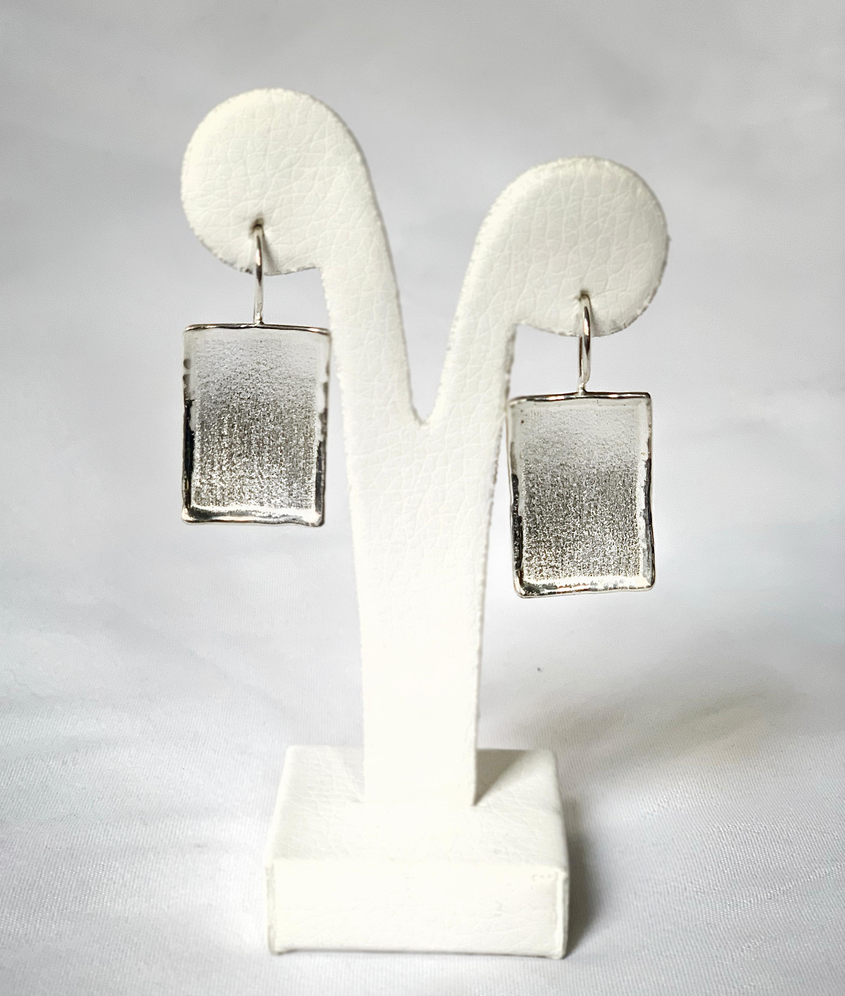 From the Yianni Creations Ammos Collection, this is a handmade artisan pair of earrings from fine silver 950 purity plated with palladium to resist against elements. These rectangular earrings catch an eye by the contrast of brushed texture and