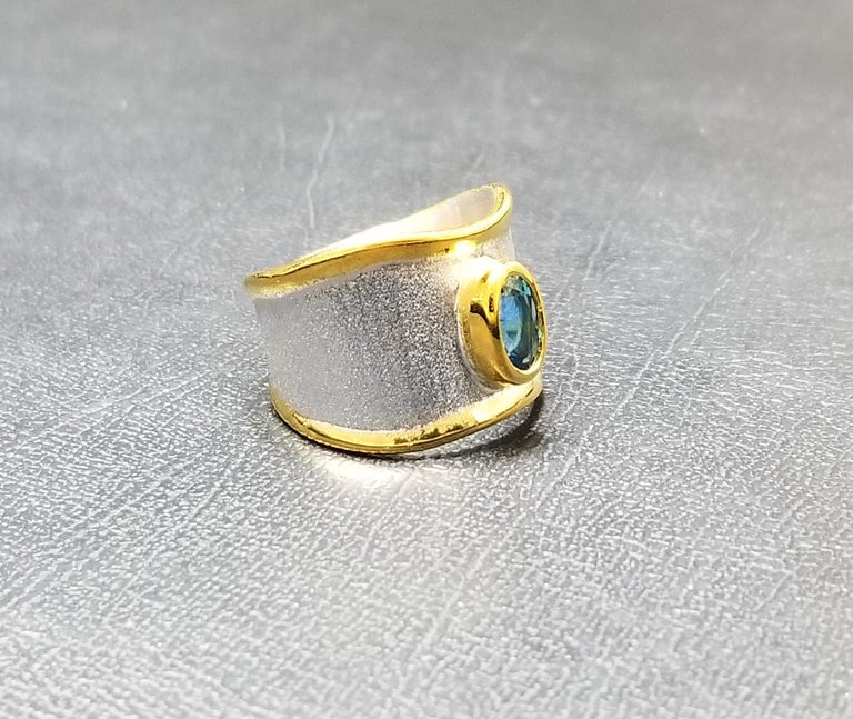 Yianni Creations - Midas Collection is a 950 purity fine silver and 24 karat gold band ring handmade in Greece. This gorgeous ring is plated with palladium to resist the elements and the unique liquid edges are decorated with a 24 Karat gold overlay