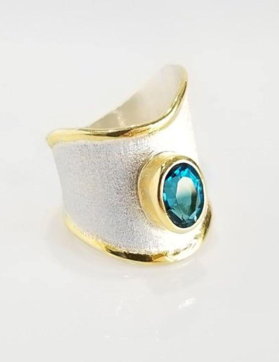 Yianni Creations Midas Collection 100% Handmade Artisan Ring from Fine Silver with a layover of 24 Karat Yellow Gold overlay 3.50+ microns. This gorgeous ring features a 1.60 Carat London Blue Topaz complemented by unique techniques of craftsmanship