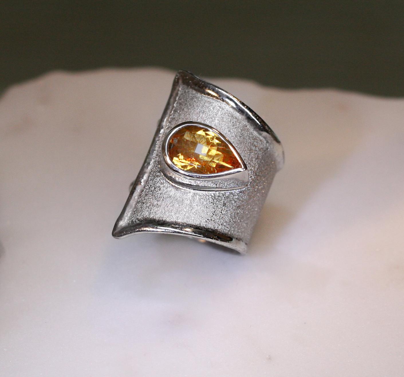Yianni Creations adjustable wide band ring handcrafted in Greece from fine silver 950 purity and plated with palladium to protect it from the tarnish is all custom-made. This gorgeous ring features 3.80 Carat teardrop chape Citrine complemented by