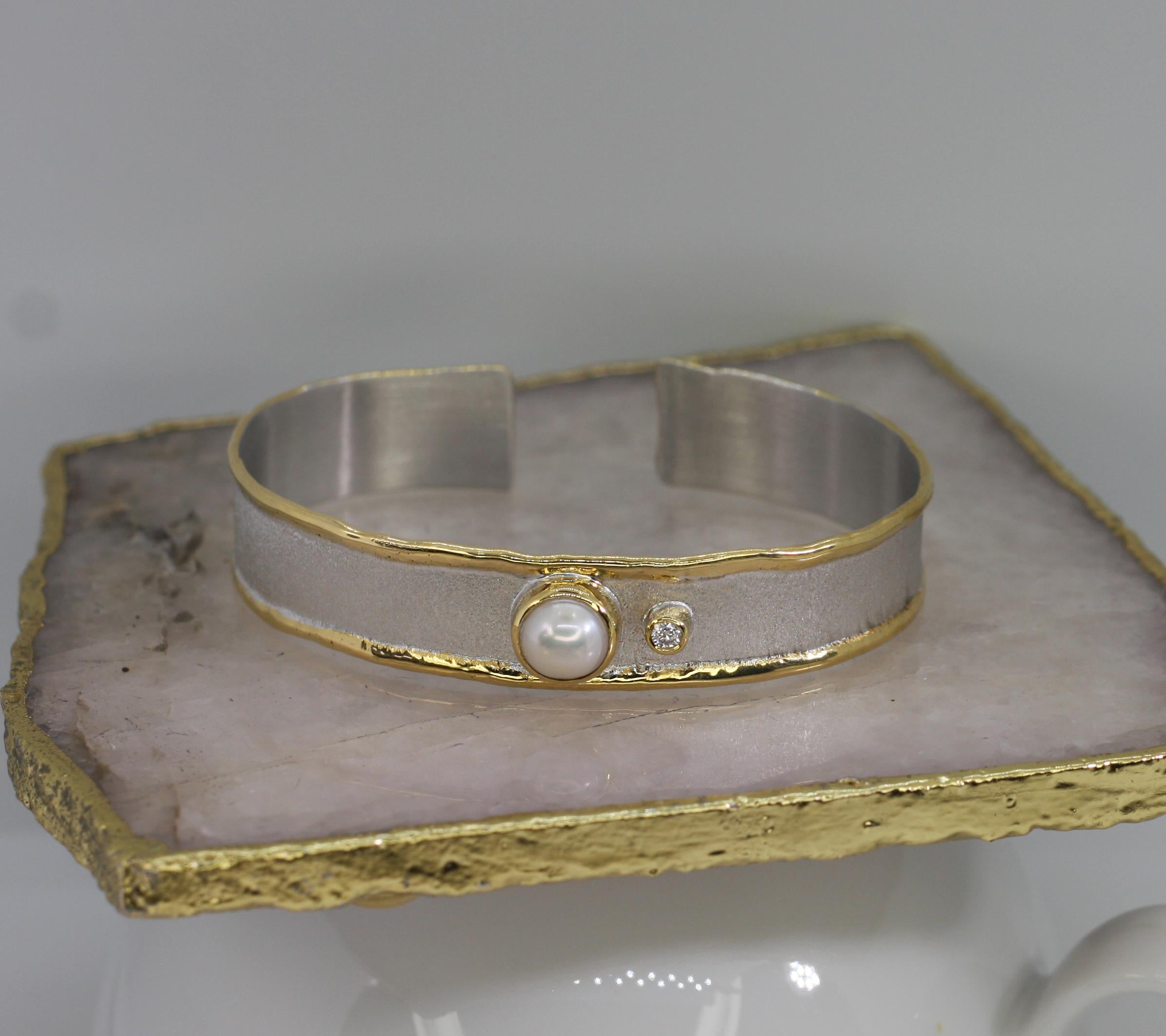 Yianni Creations cuff bracelet from Midas Collection all handcrafted from fine silver 950 purity and plated with palladium to resist the elements. This gorgeous artisan cuff bracelet features a natural Pearl accompanied by 0.07 Carat brilliant-cut