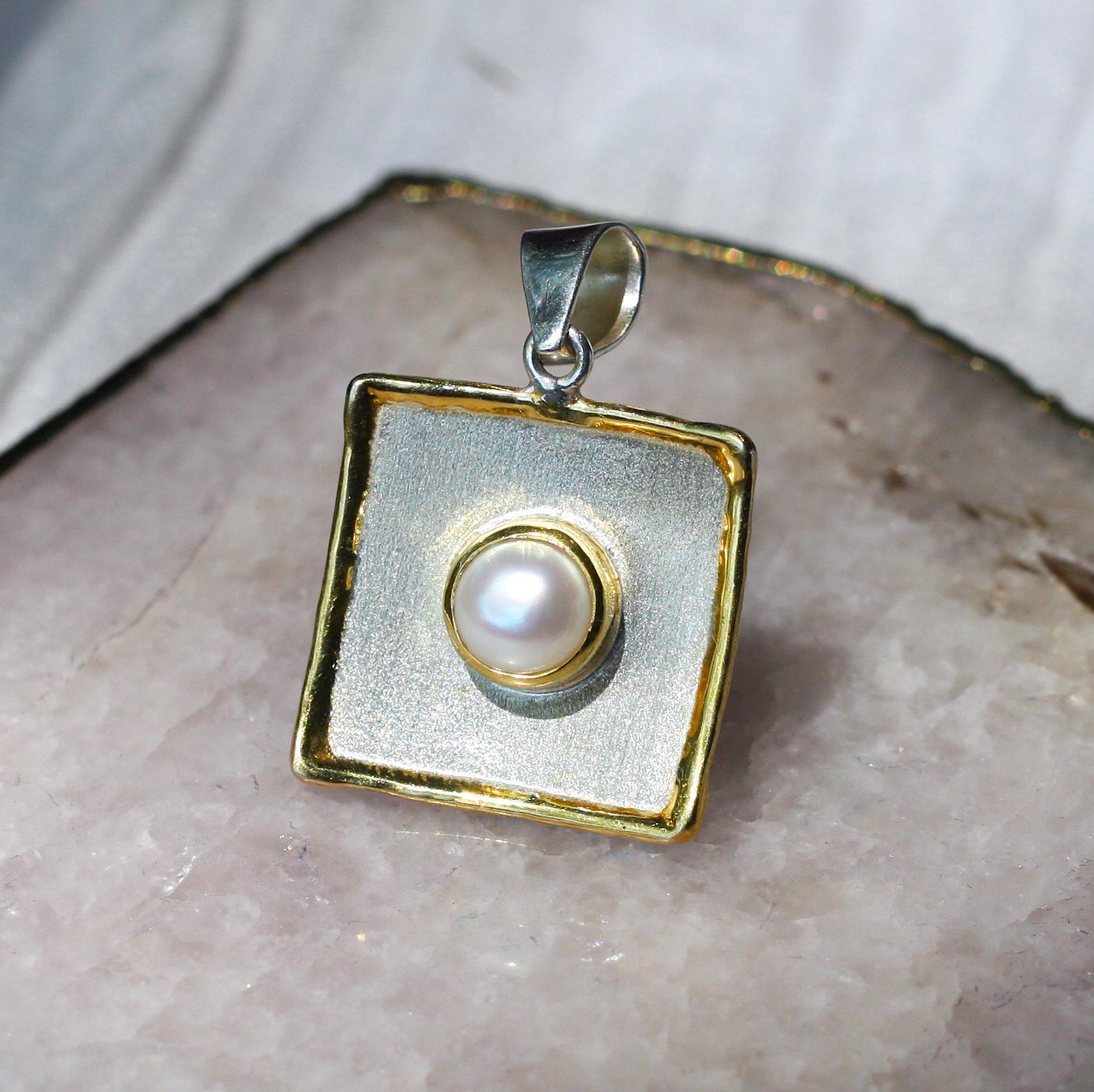 This is Yianni Creations handmade artisan slide from Midas Collection crafted in Greece from fine silver 950 purity and plated with palladium to resist the elements. This square-shaped dangle pendant features 7MM freshwater pearl. The unique look is