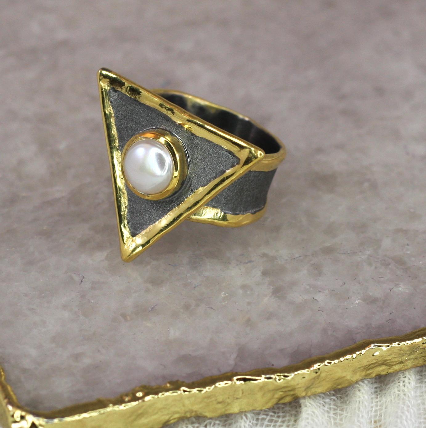 This 8 mm freshwater pearl ring from Yianni Creations is a unique ring handcrafted in Greece from Fine Silver 950 purity and plated with palladium to resist the elements. This triangular ring is finished with black rhodium and the edges are