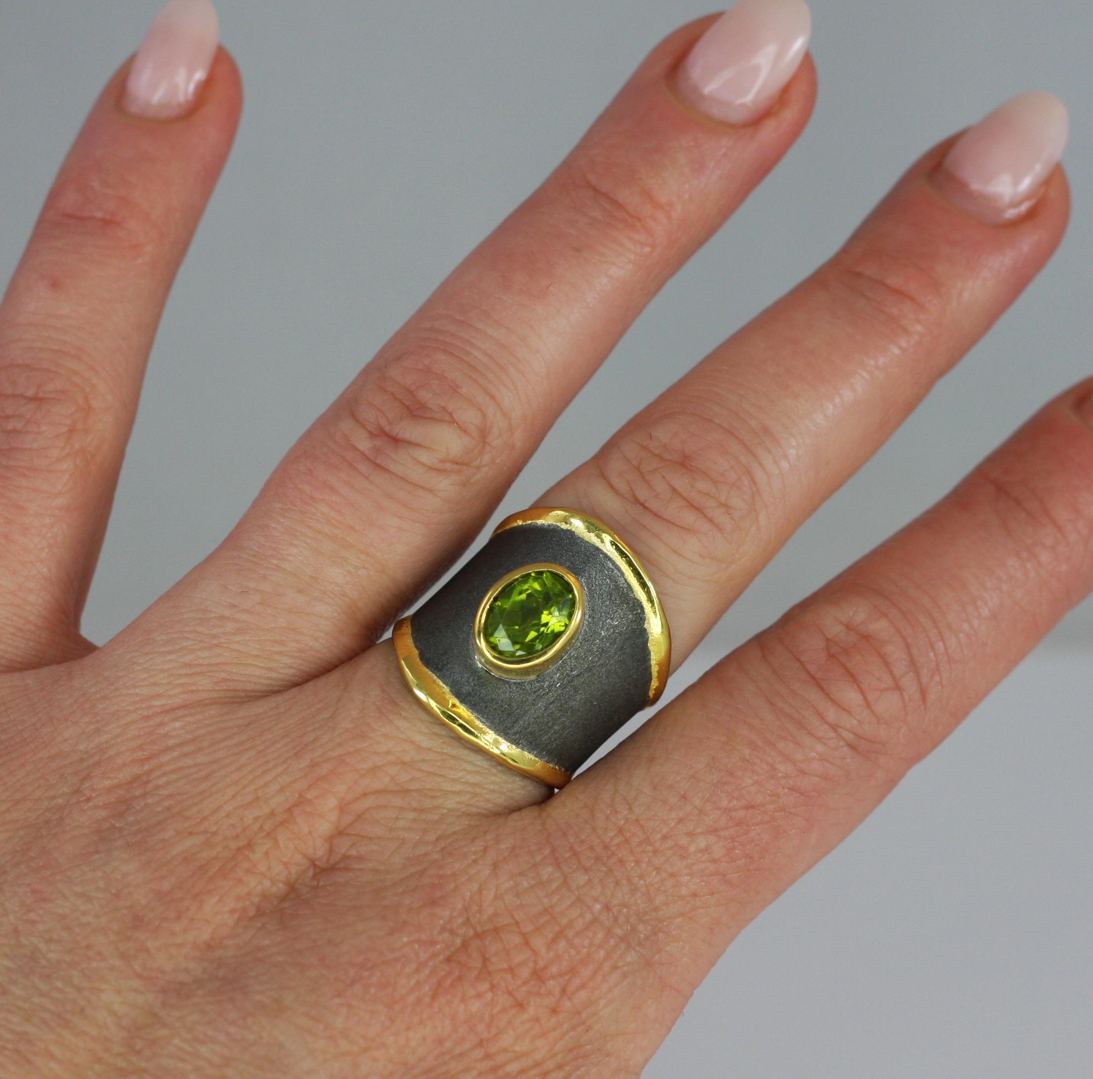 From Yianni Creations - Eclyps Collection this is 950 purity fine silver ring handmade in Greece. The ring is plated with Black Rhodium and decorated with 24 karat gold. The unique look is completed by 2.00 Carat oval cut Peridot. Contact us for