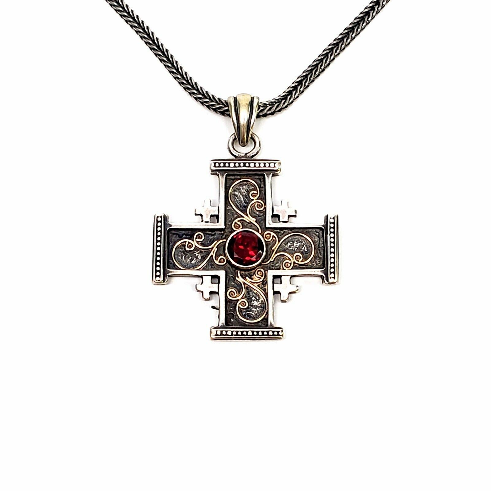 Yigal Avinoam Sterling Silver Crusaders Cross pendant with wheat chain.

The lovely sterling silver Crusaders Cross features 14k yellow gold flourish accents and a round faceted garnet at its center. Beaded accents at ends of cross.

Measurements: 