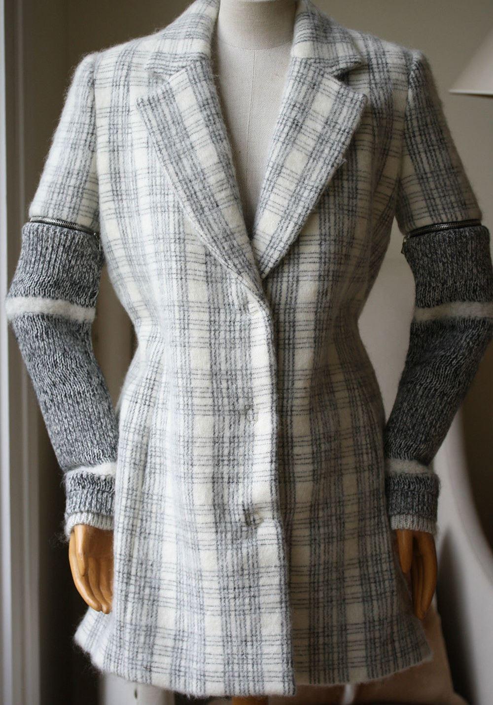 This plaid wool Yigal Azrouel coat features a notched collar, welt hip pockets and detachable exposed zipped marled knit sleeves. Hidden snap button front closure. 45% virgin wool, 44% mohair, 11% nylon. Fully lined.

Size - US 2 (UK 6, FR 34, IT