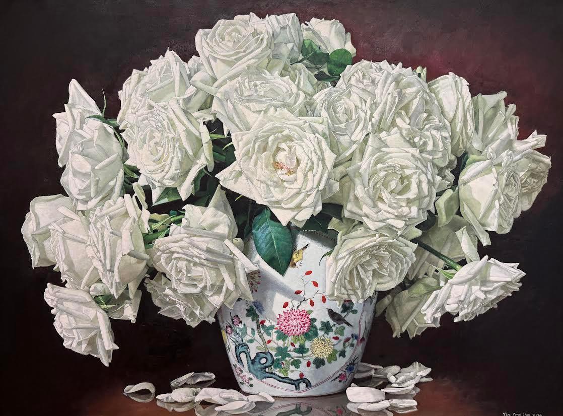 This piece, “Porcelain Jar with Roses”, is a 32x43 oil painting on canvas by artist Yin Yong Chun. Featured is an abundant bouquet of creamy white roses spilling outward from a delicate, hand-painted porcelain jar adorned with floral motifs and tiny