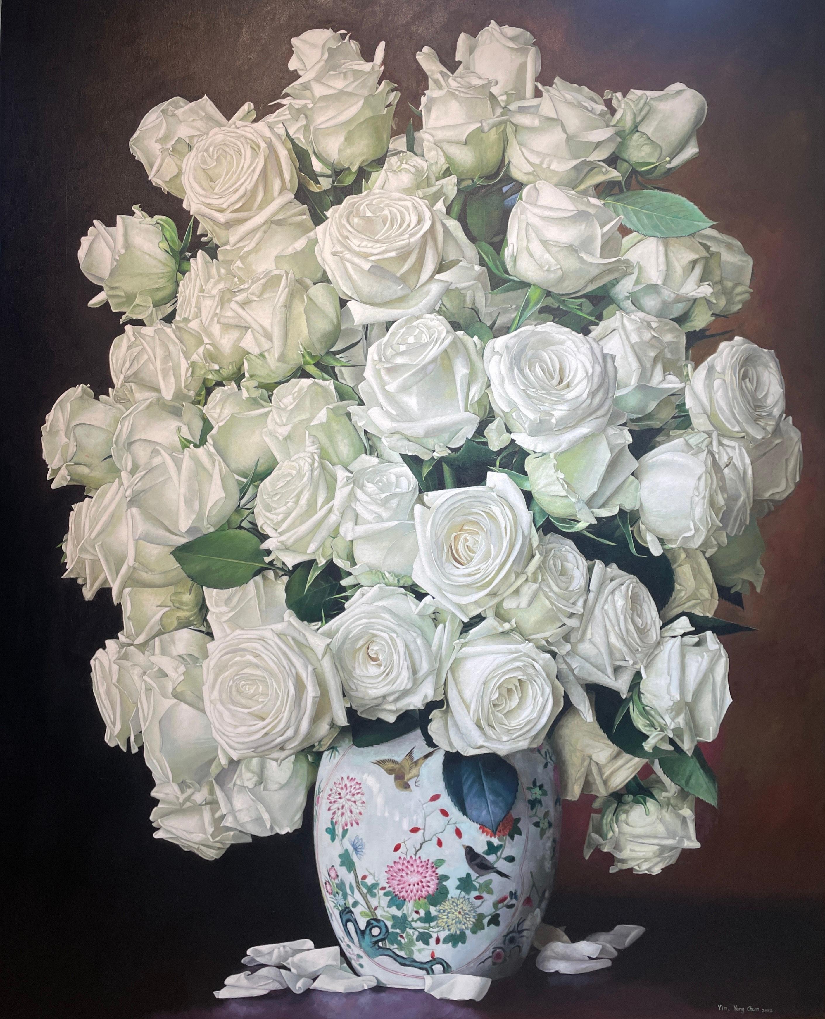 This floral still life, "White Roses with China Pot", by artist Yin Yong Chun is a 60x48 oil painting on canvas featuring a bouquet of white roses in an ornate floral porcelain vase with fallen white petals on the table. A dark moody background