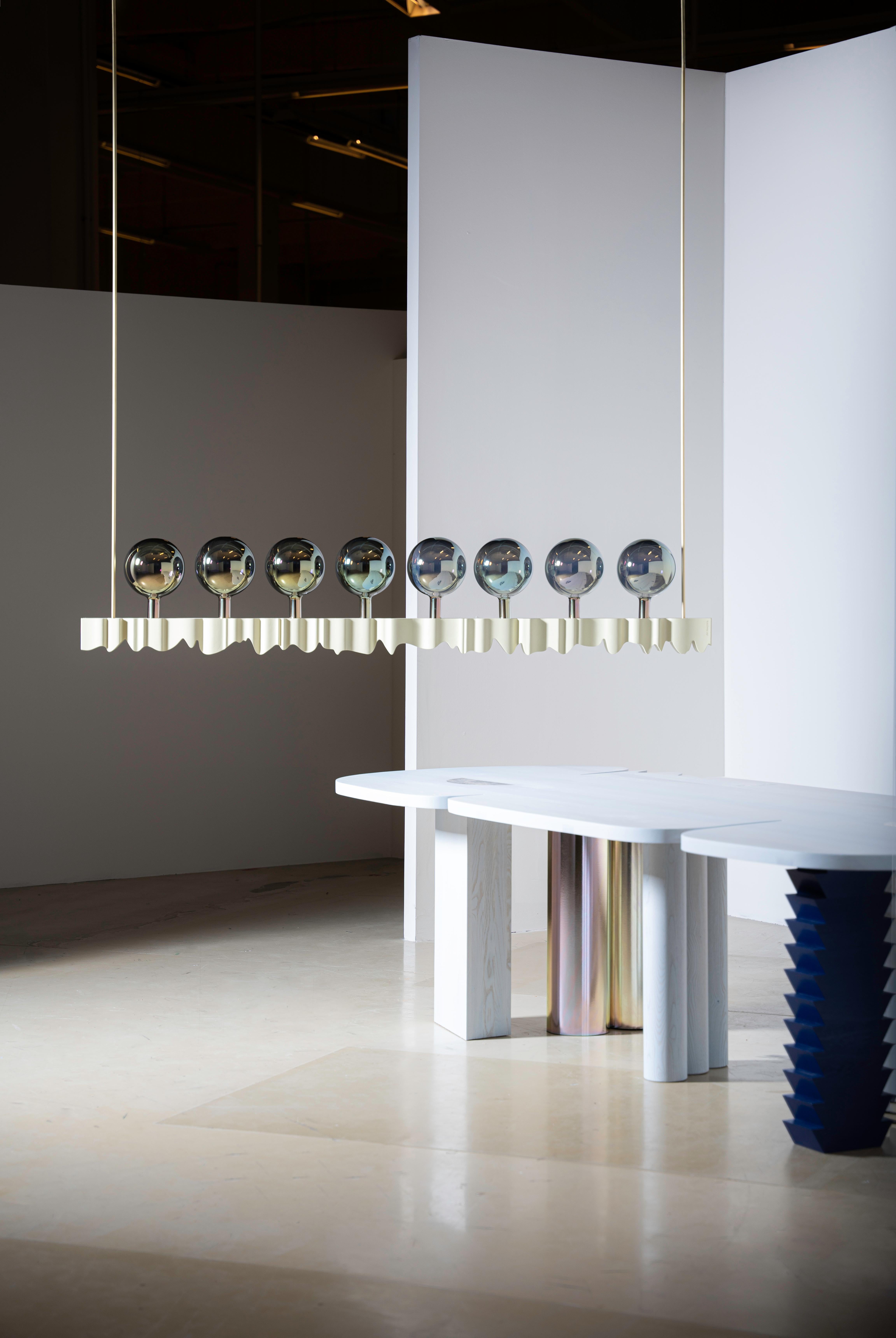 YKB is a monumental luminaire, contrasting lacquered solid ash wood, brass construction, and metal coated glass spheres. The aesthetics of YKB is an authorial interpretation and a bow to the work of Czech architect Jan Kotěra and Slovak architect