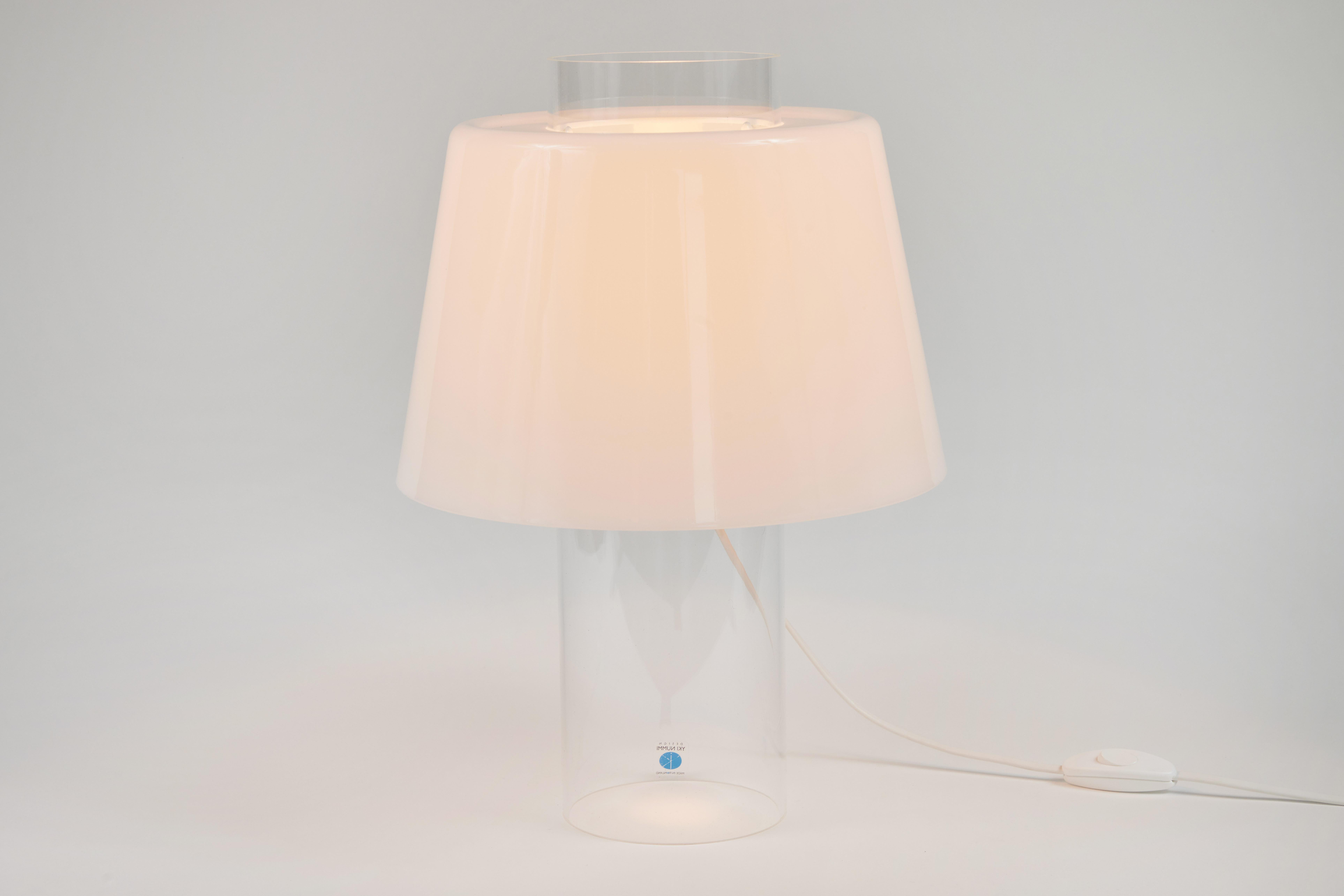Yki Nummi 'Modern Art' table lamp for Innolux Oy, Finland. Designed in the 1955 for Stockmann-Orno, Nummi's iconic design is comprised of an opaline white acrylic conical shade that fits atop a clear acrylic cylinder. As Nummi once observed, “People