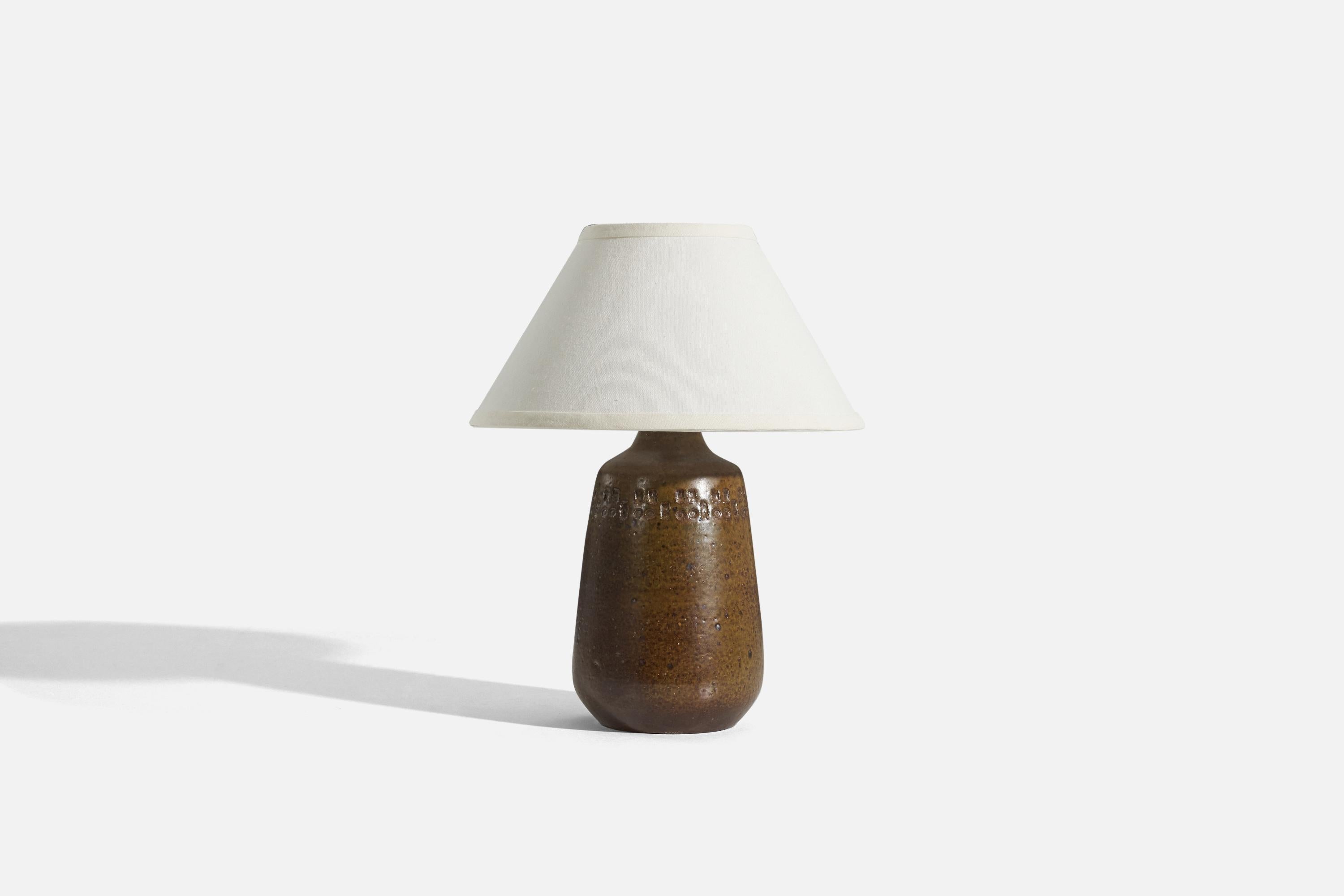 A brown glazed stoneware table lamp designed and produced by Yngve Blixt, Sweden, 1960s. 

Sold without lampshade. 
Dimensions of Lamp (inches) : 12.5625 x 5.75 x 5.75 (H x W x D)
Dimensions of Shade (inches) : 5.25 x 12.25 x 7.25 (T x B x