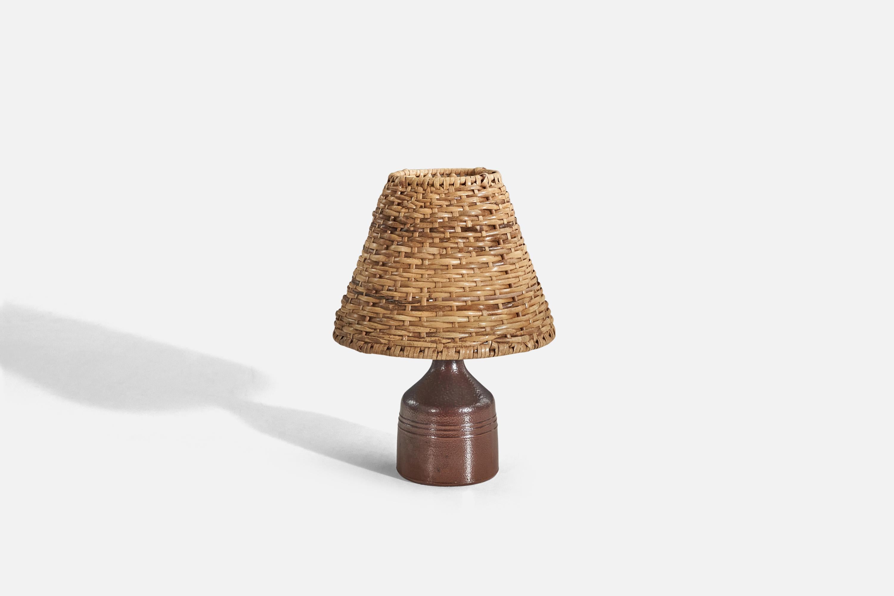 A brown, glazed stoneware table lamp designed by Yngve Blixt and produced by Höganäs, Sweden, 1960s. 

Sold with rattan lampshade. 
Dimensions of lamp (inches) : 7.06 x 3.35 x 3.35 (Height x Width x Depth)
Dimensions of shade (inches) : 3.5 x 7