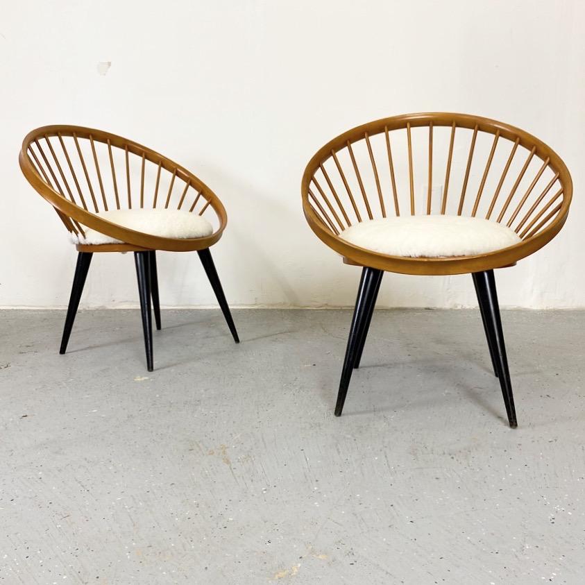 Vintage pair of circle chairs with shearling upholstery. A striking design by Yngve Ekstrom with birch frames.