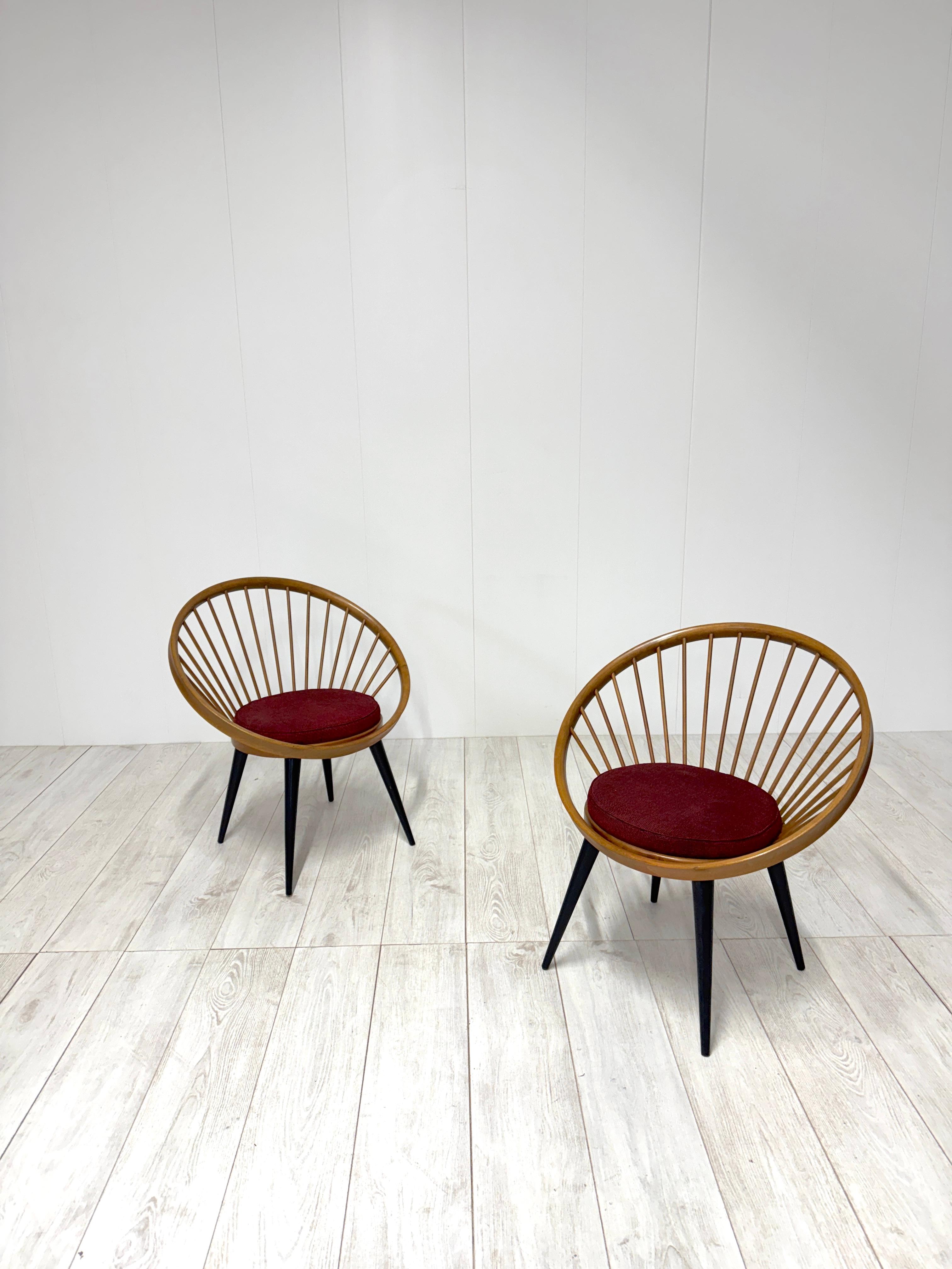 Pair of armchairs i wood and fabric upholstered seat.
The Circle Chair gets its name from its distinctive circular backrest held together by round rods.

Designed in 1958 by Swedish designer Yngve Ekström for Italian manufacturer Gessef, the Circle