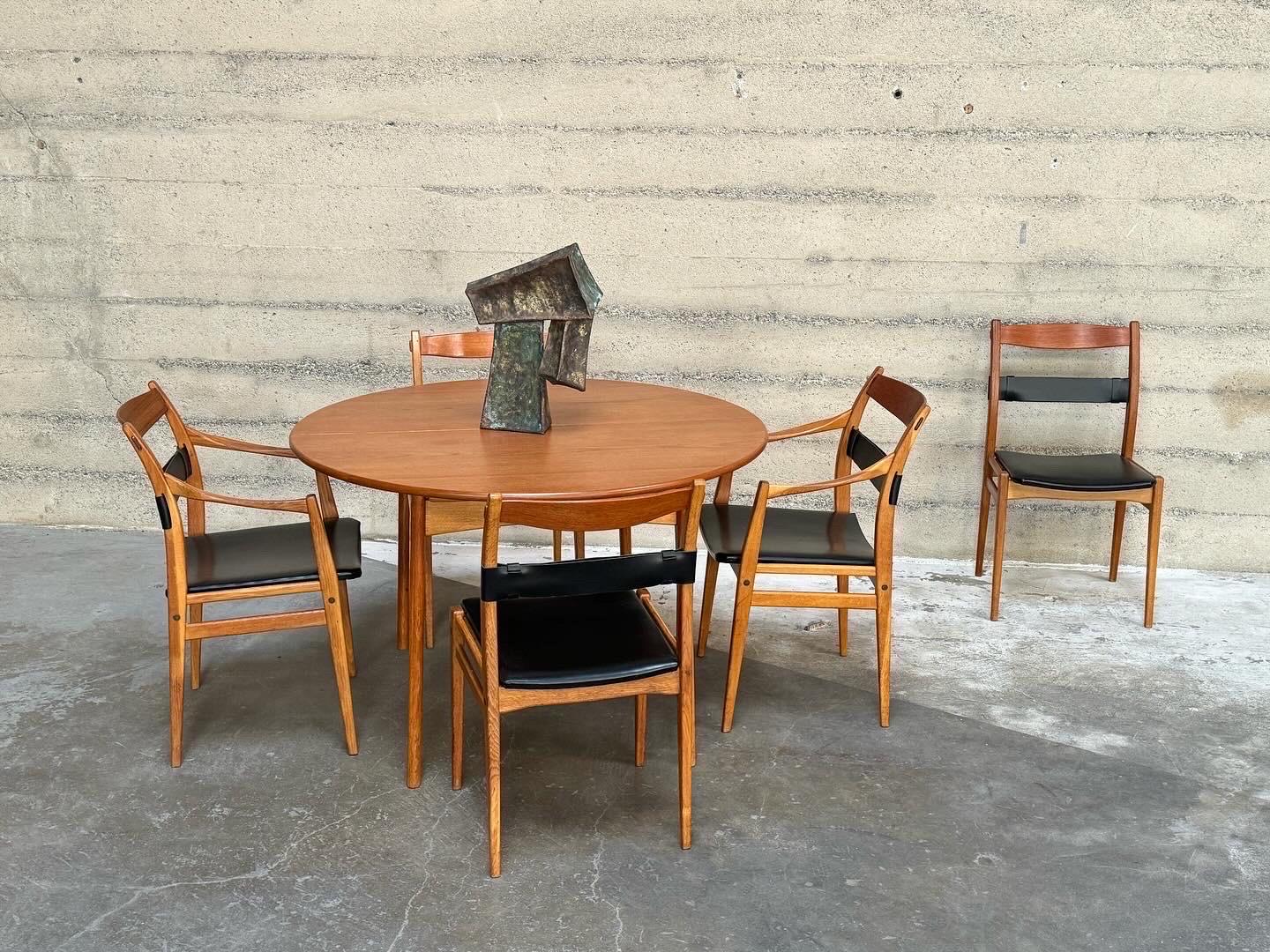 Dining set designed by Yngve Ekstrom for Dux of Sweden late 1950s early 1960s. The set is constructed of teak and oak, the dining chairs are of oak, leather, vinyl with brass hardware fasteners  and the dining table has a teak top with oak legs with