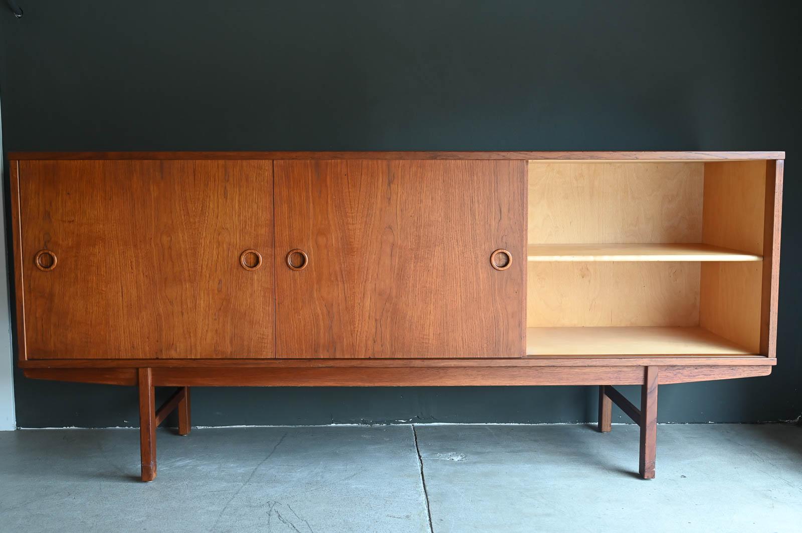 Yngve Ekstrom For Dux 'Ulvö' Teak Credenza, ca. 1959.  Beautiful teak and teak veneer with sculpted pulls and sliding doors with dovetail drawers in center.  Wonderful teak grain and color, functional piece that offers lots of storage and adjustable