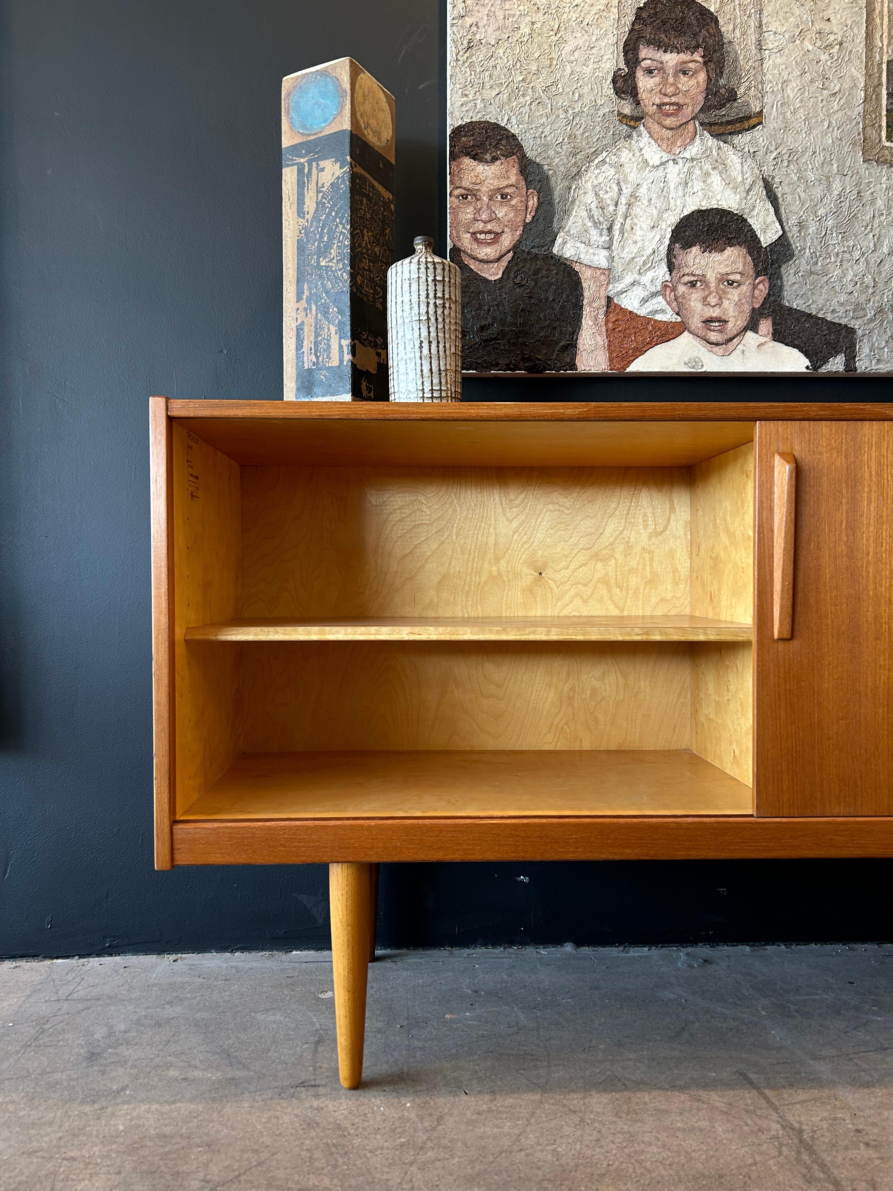 Yngve Ekström for Troeds sculpted teak credenza circa mid 1950’s. Has 5 drawers with solid teak pulls and a sliding door with adjustable interior storage. Newly finished.
