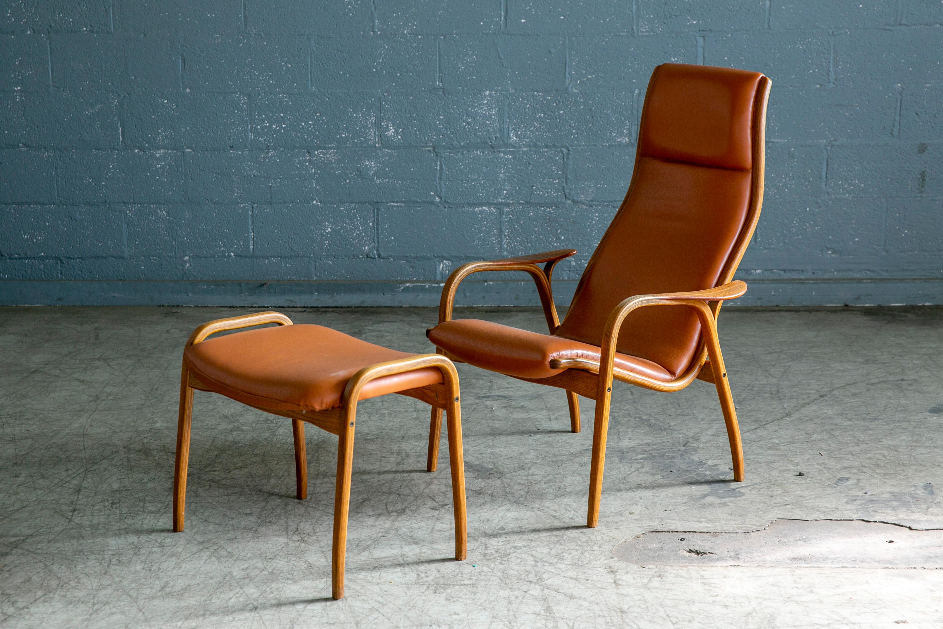Swedish Yngve Ekstrom Lamino Chair in leather with ottoman in Laminated Walnut with Teak