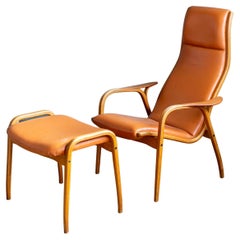 Yngve Ekstrom Lamino Chair in leather with ottoman in Laminated Walnut with Teak