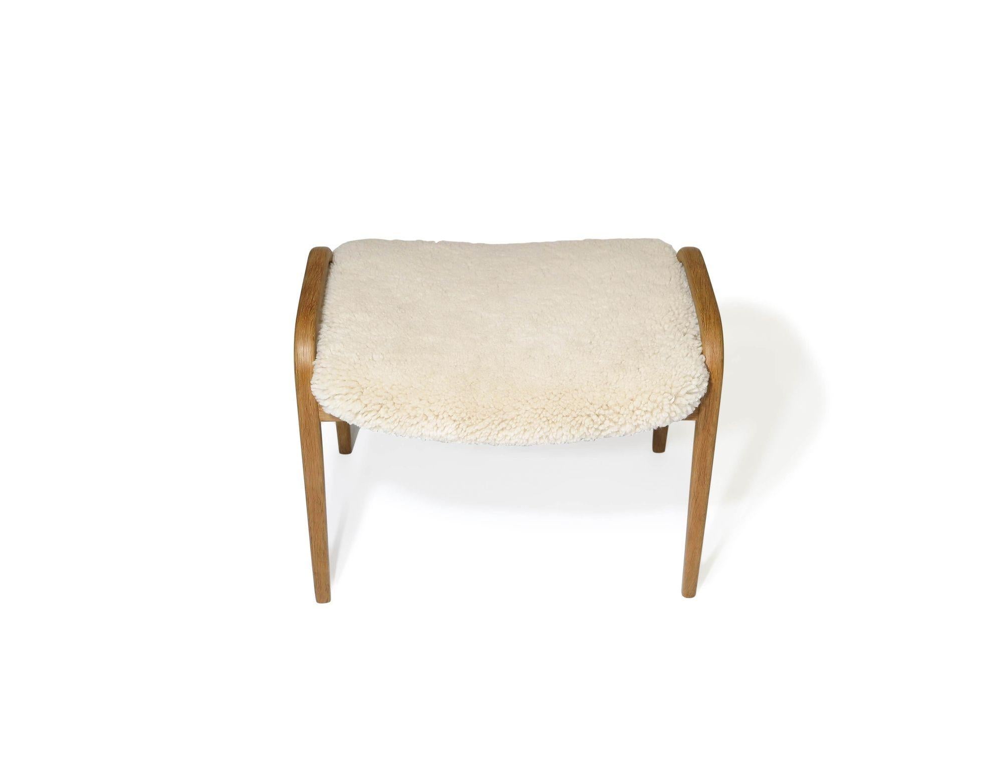 Midcentury Swedish Lamino ottoman designed by Yngve Ekström for Swedese, 1955, Sweden. The ottoman is crafted of steamed birch frame and newly upholstered in sheepskin. 
Measurements 
W 23.50'' x D 18'' x H 19
Seat Height 17.50''.