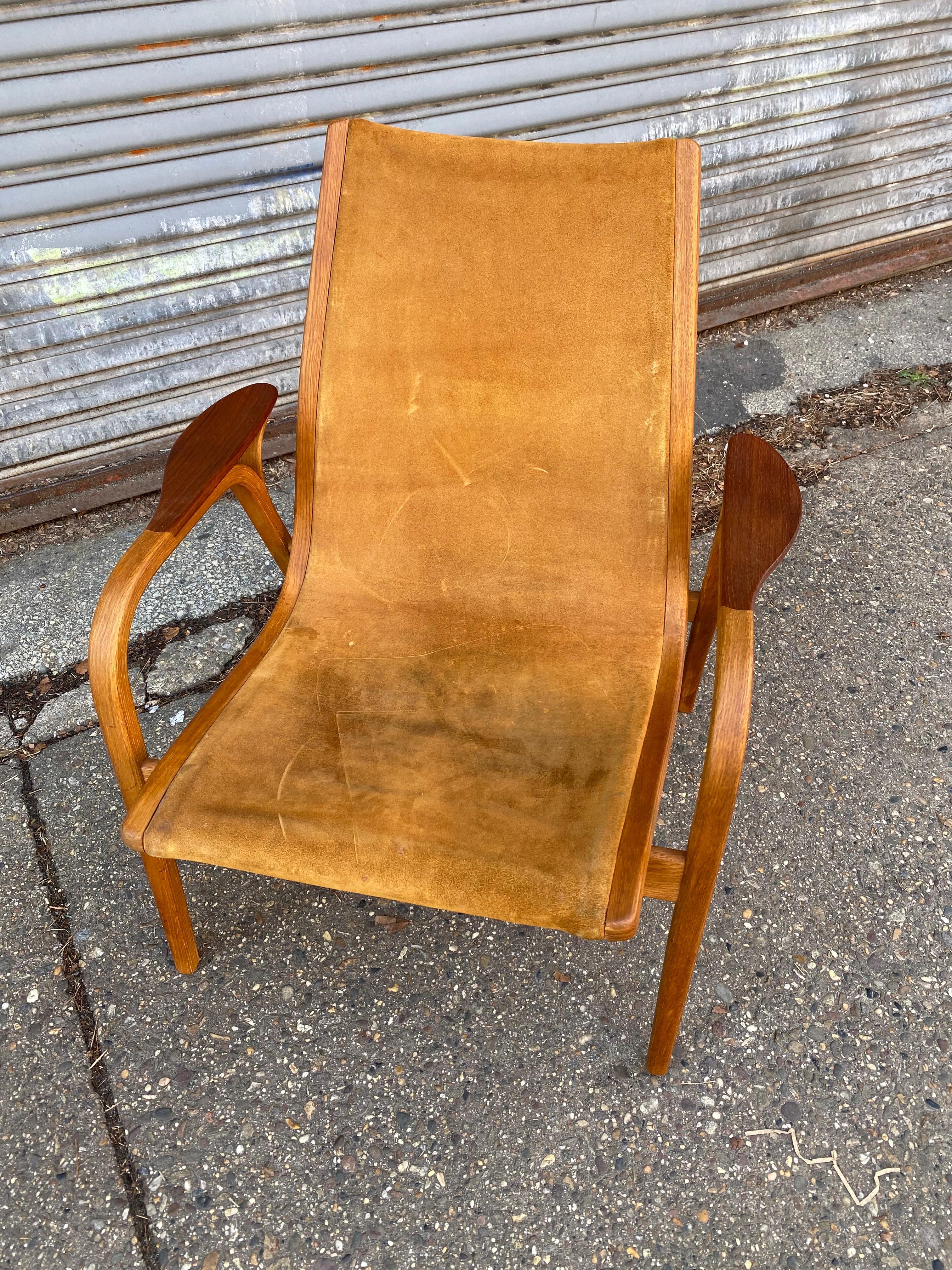 Low Back Yngve Ekstrom Lamino Chair in Tan Suede Leather.  Wood is Very Nice Condition!  This one saw a lot of use so leather sling is well worn with marks and wear.  Bent Oak Frame with Teak Armpads.  Several Lamino Chairs available!