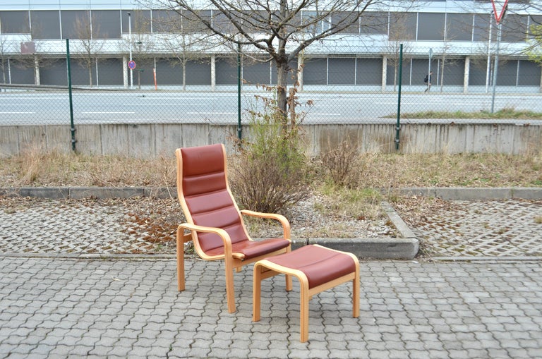 Yngve Ekström Modell Melano Highback easy lounge chair with ottomane.
Oxred leather in beech wood. 
The chair is comfortable and has a beautiful vinatge patina.

Measures:
Chair
width 71 cm
depth 75 cm
height 105 cm
seat height 42-33