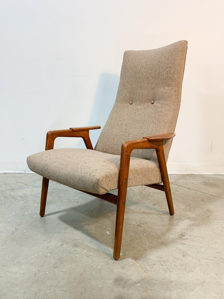 Angular high back lounge chair by Swedish designer Yngve Ekstrom and made by Pastoe of the Netherlands in the 1950s. Solid oak frame with superb winged arm caps that capture the forward-looking design attitudes of the time. The contoured seat