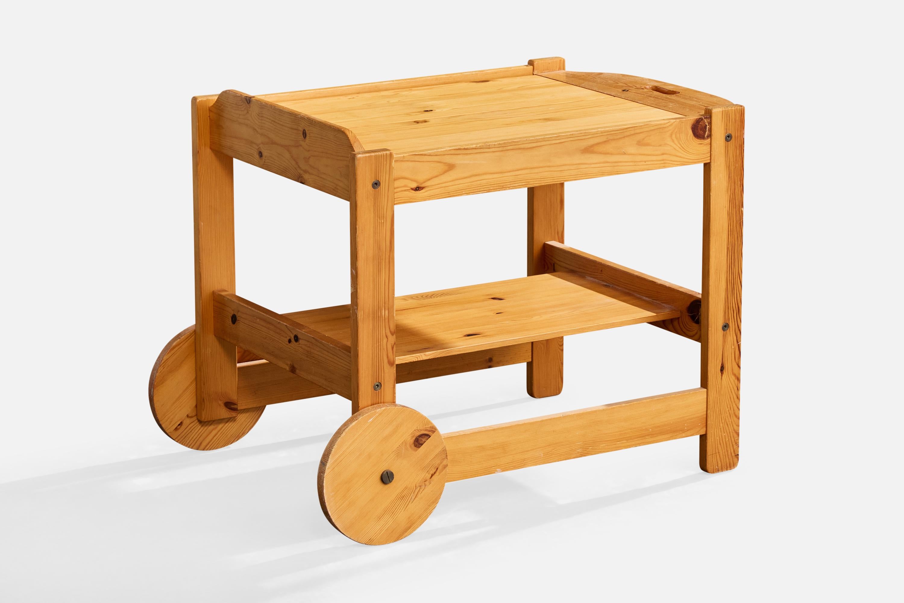 A pine serving cart or bar cart designed by Yngve Ekström and produced by Lystella, Sweden, c. 1970s.

Minor scrapes on wheels and back legs.

Overall Dimensions (inches): 22.6