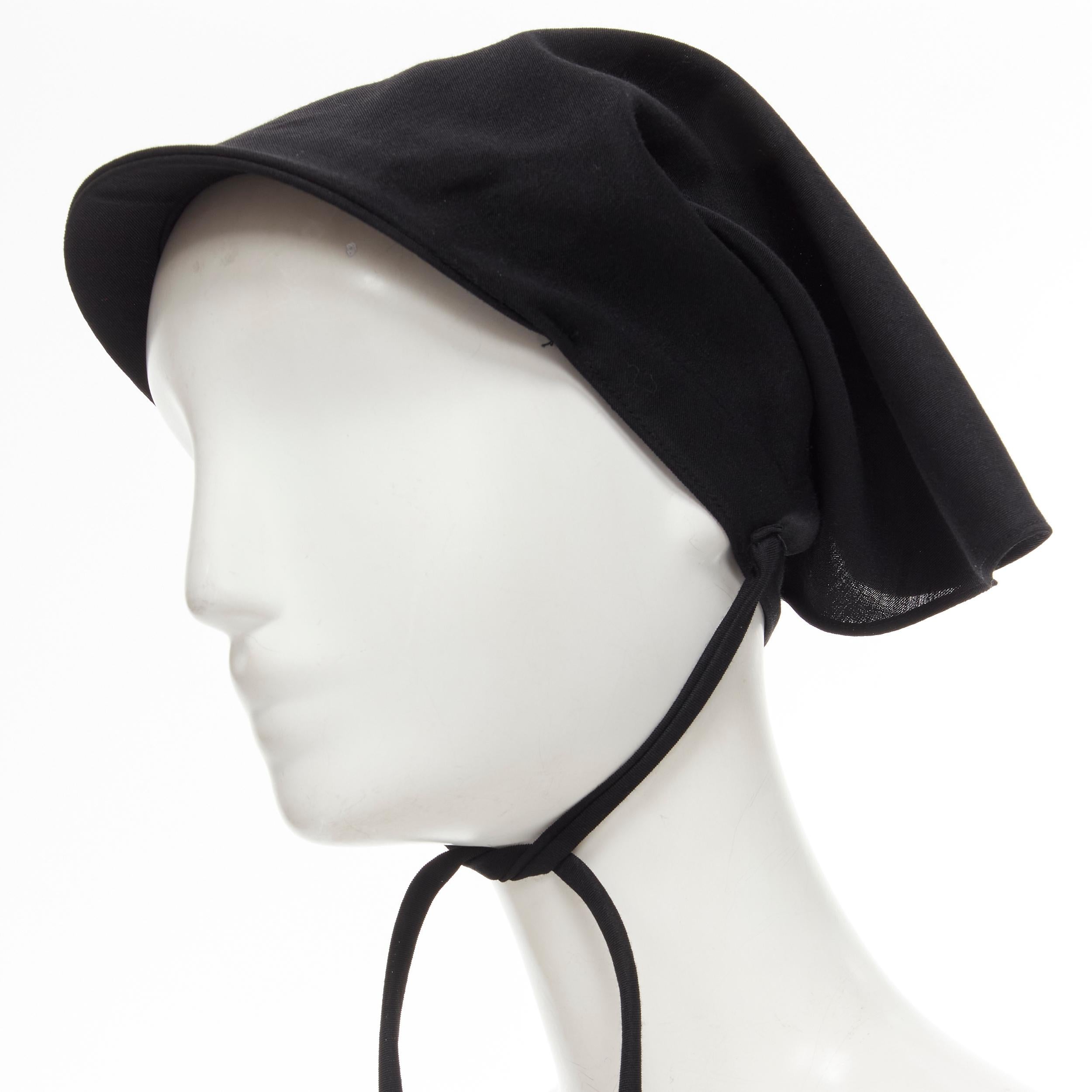 YOHJI YAMAMOTO 1980's Vintage black wool apostolnik wimple headscarf nurse hat 
Reference: CRTI/A00653 
Brand: Yohji Yamamoto 
Designer: Yohji Yamamoto 
Collection: 1980s 
Material: Wool 
Color: Black 
Pattern: Solid 
Closure: Tie 
Extra Detail: