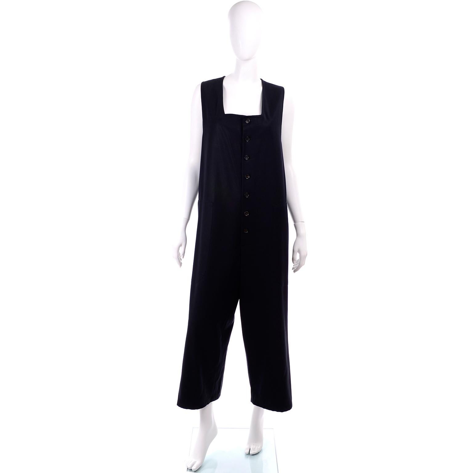 This is a wonderful Yohji Yamamoto vintage midnight blue jumpsuit from the 1990's.  This straight, sleeveless oversized jumpsuit is in a midnight blue gabardine wool twill with a square neckline. There are buttons down the center front and slash,