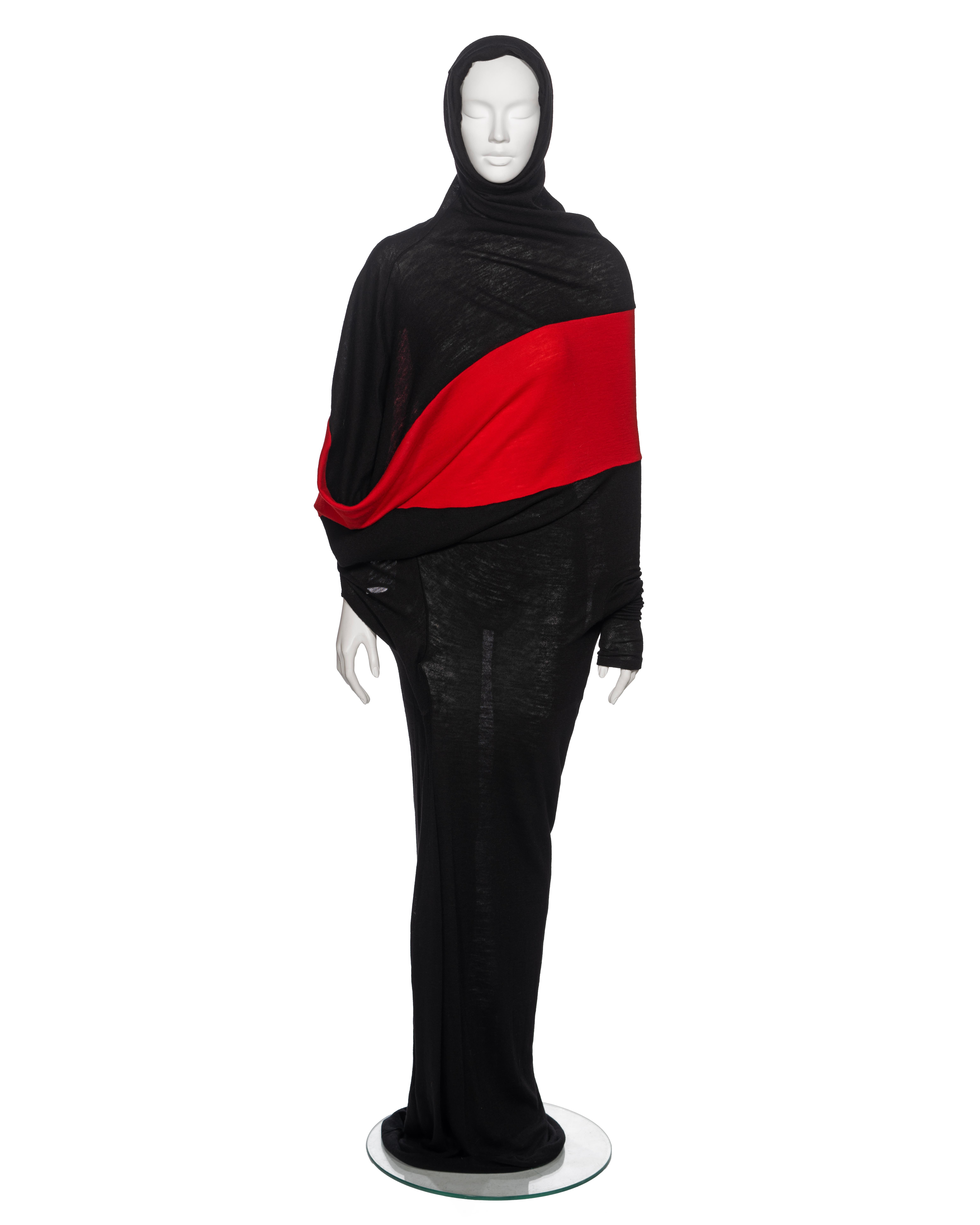 ▪ Yohji Yamamoto Black and Red Wool Asymmetric Convertible Maxi Dress
▪ Fall-Winter 2012 
▪ Sold by One of a Kind Archive 
▪ Crafted from high-quality fine wool jersey
▪ A striking contrasting red panel runs horizontally around the bodice
▪ The