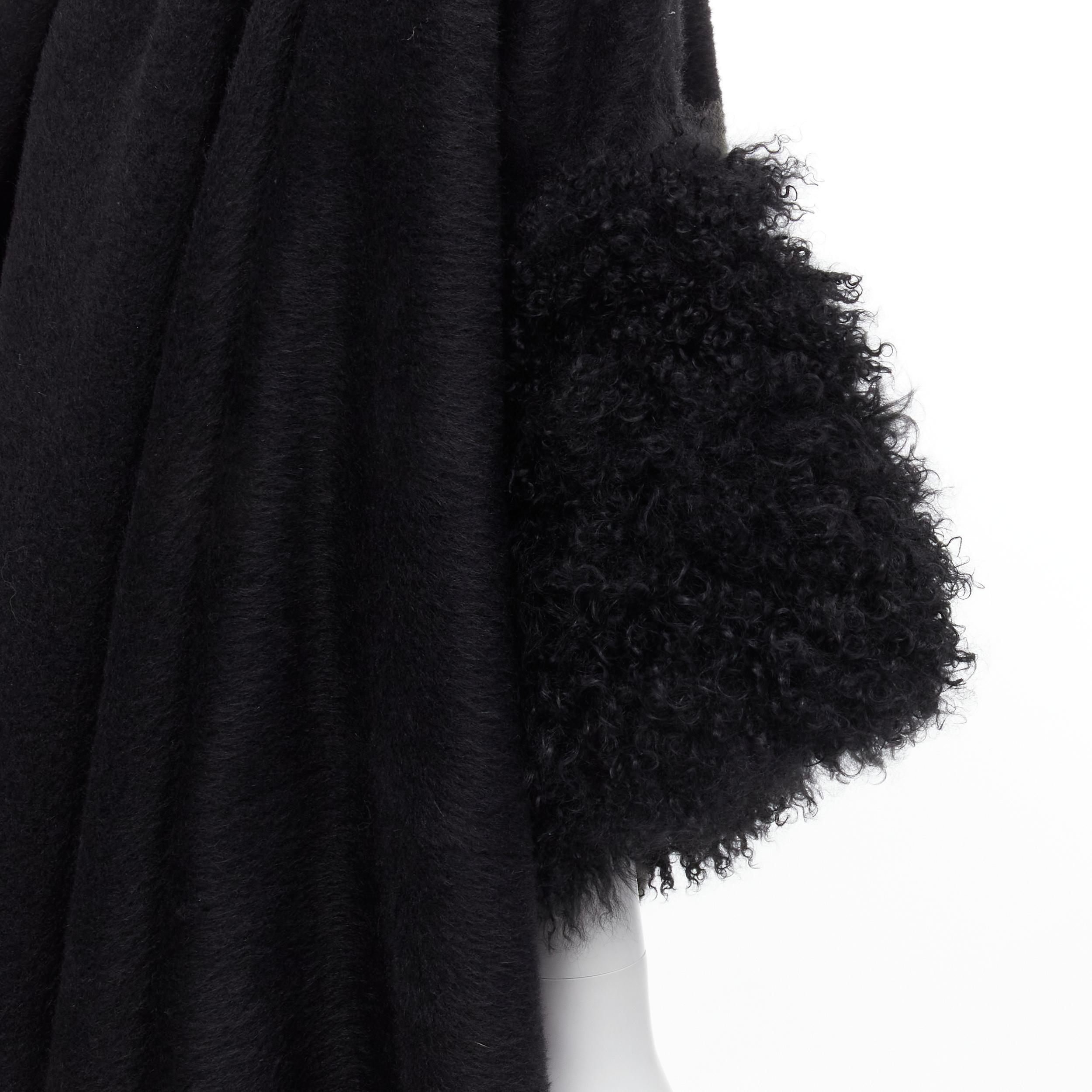 YOHJI YAMAMOTO black brushed wool shearling cuff draped cocoon coat S 
Reference: CRTI/A00547 
Brand: Yohji Yamamoto 
Material: Wool 
Color: Black 
Pattern: Solid 
Extra Detail: Extremely oversized coat. Draped collar. Short sleeve curly shearling