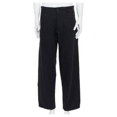 YOHJI YAMAMOTO pantalon noir en laine mélangée à bords bruts ornés de boutons JP2 M