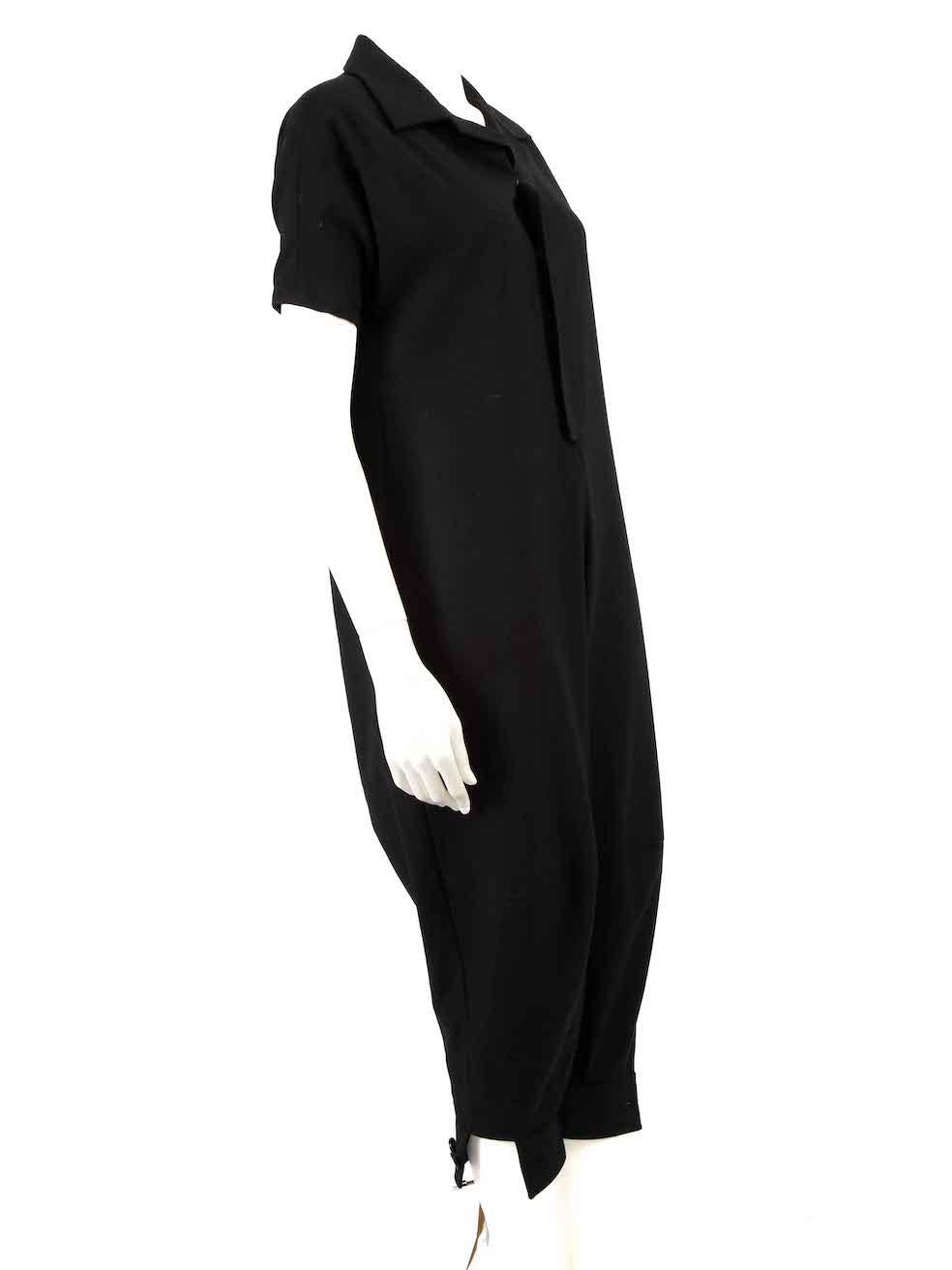 CONDITION is Very good. Minimal wear to jumpsuit is evident. Minimal wear to the rear lining with light marks on this used Yohji Yamamoto designer resale item.
 
 
 
 Details
 
 
 Black
 
 Wool
 
 Jumpsuit
 
 Snap button fastening
 
 V-neck
 
 Short