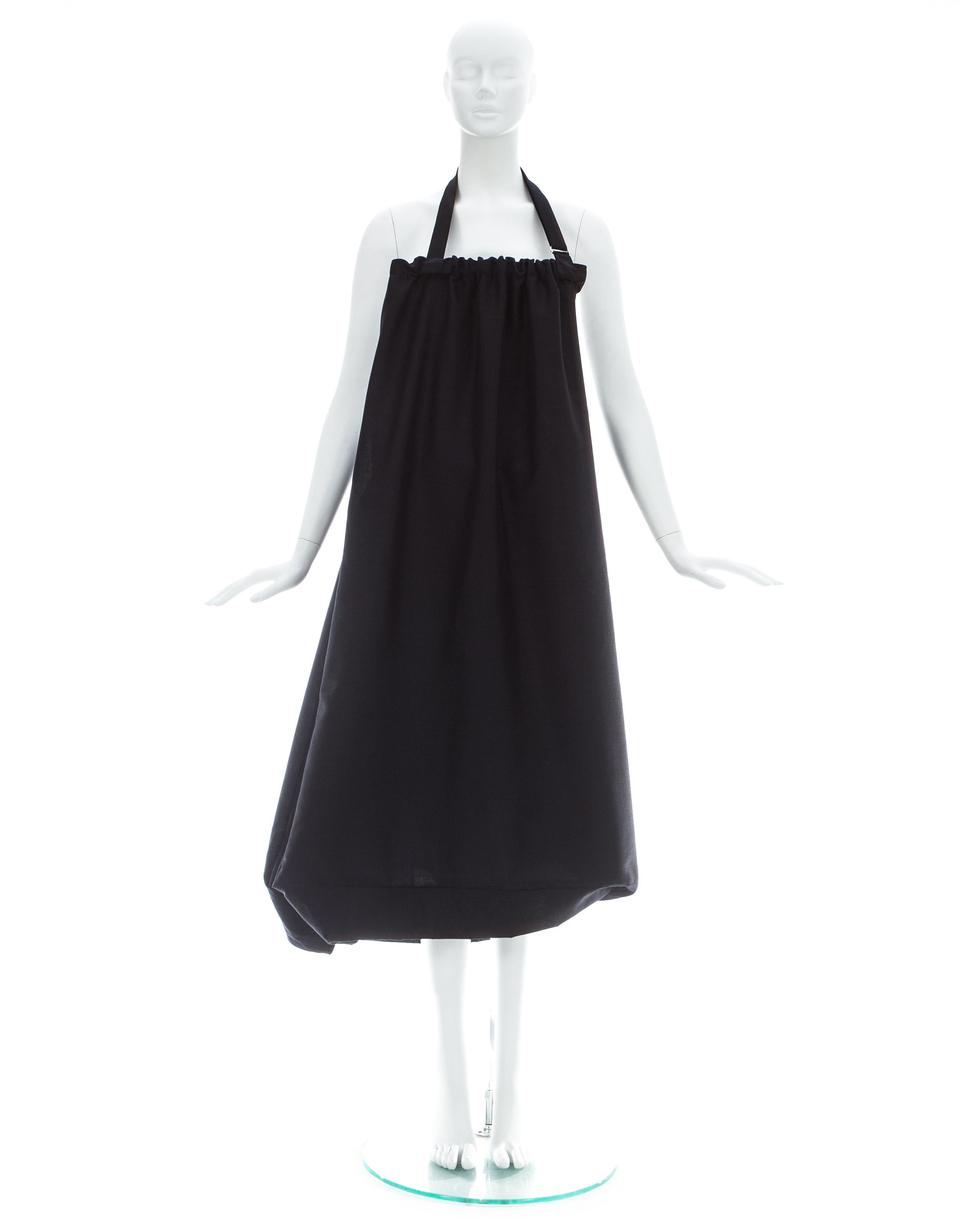 Yohji Yamamoto; Black wool dress with built-in functioning bag and adjustable strap. This garment can also be worn as a skirt

Spring-Summer 2001