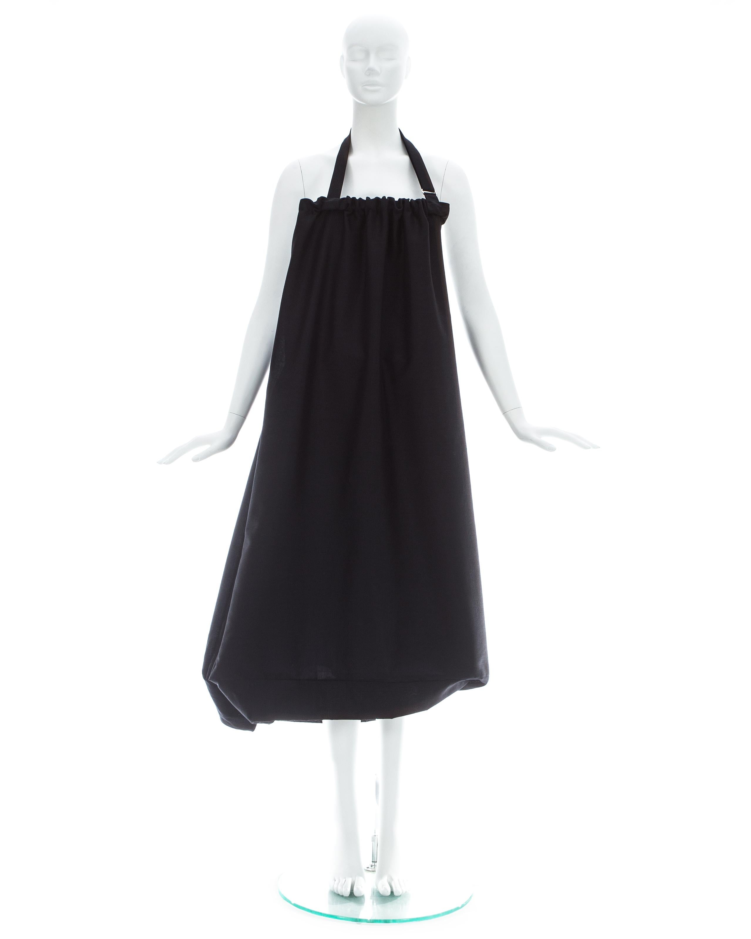 Yohji Yamamoto; Black wool dress with built-in functioning bag and adjustable strap. This garment can also be worn as a skirt  

Spring-Summer 2001