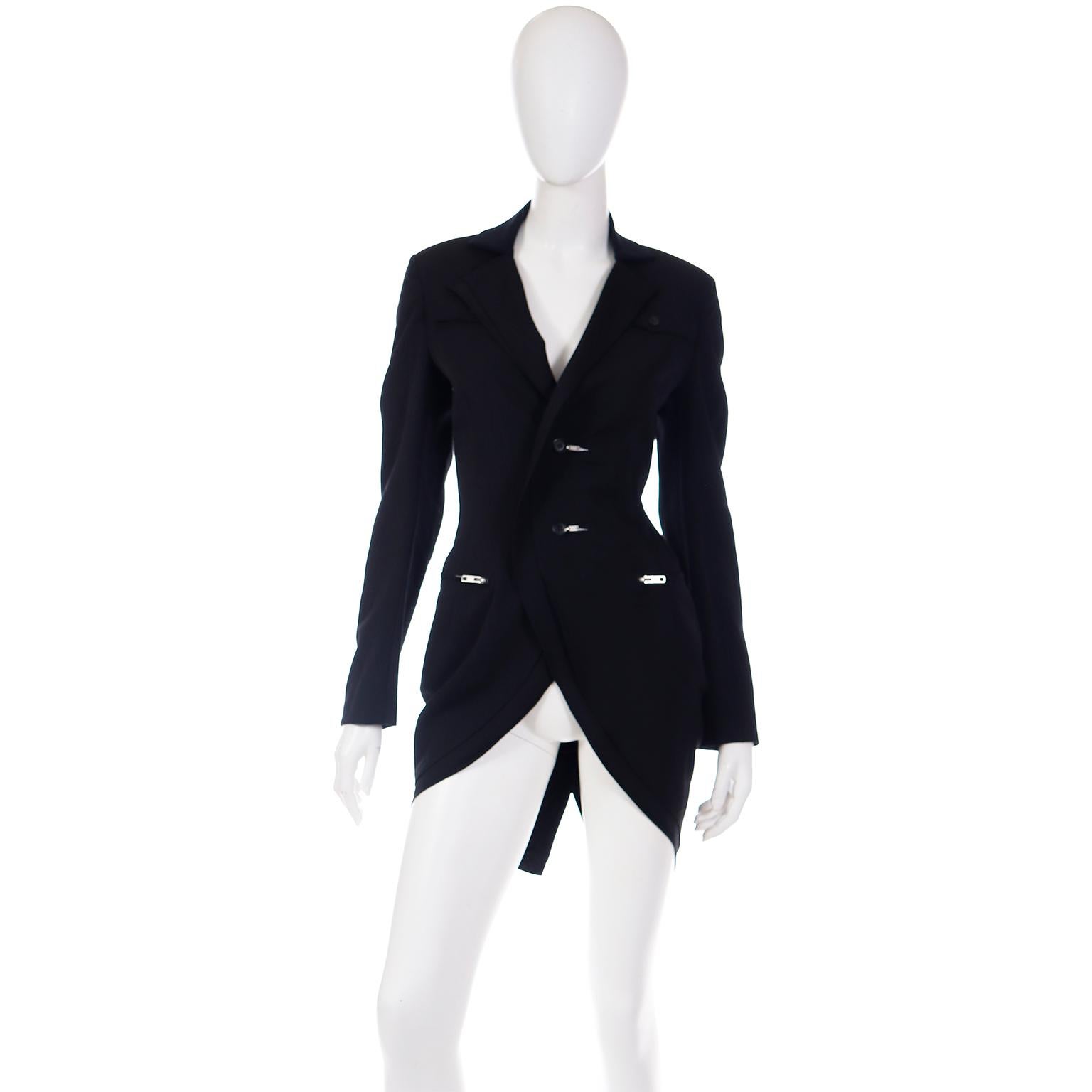This Yohji Yamamoto avant garde black wool tuxedo style jacket has so much style! The jacket has 2 side slit pockets with zippers and it closes with two front center buttons with zippers on the button holes!  Yohji Yamamoto always included details