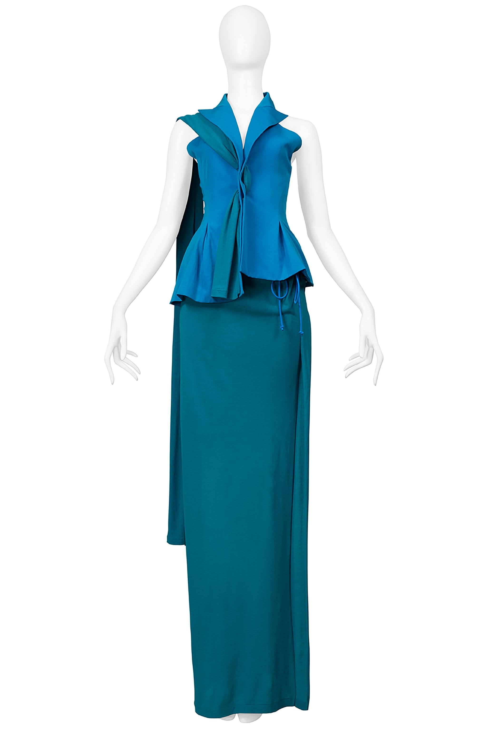 Resurrection Vintage is thrilled to present a vintage Yohji Yamamoto evening ensemble in turquoise blue and green teal. The ensemble features a fitted tuxedo vest with a scarf closure and racer back, detachable mesh sleeves with elastic at the