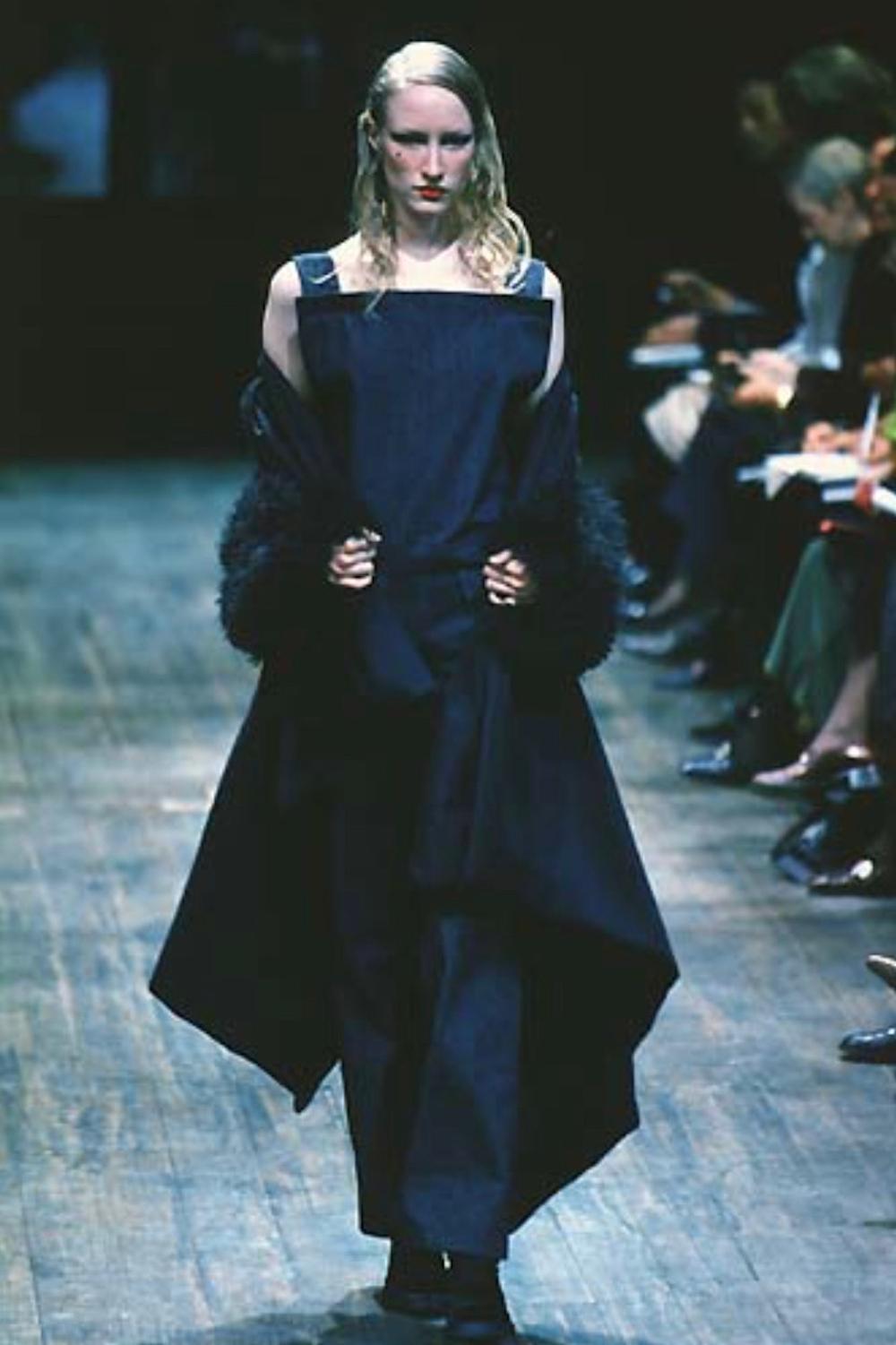 - Autumn/Winter 1997 Runway collection by Yohji Yamamoto

- Sold by Mae Vintage London 

- Black wool gabardine jumpsuit with square bib front very low back

