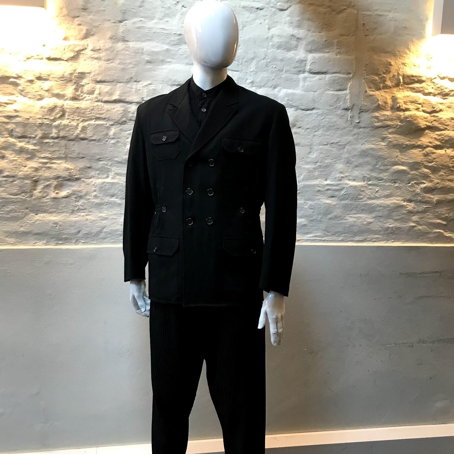 Yohji Yamamoto Military Style Jacket made in Japan from cotton. 

Yohji Yamamoto is known for the avant-garde spirit of his clothing. His signature oversized silhouettes in black often feature drapery in varying textures. Since the establishment of