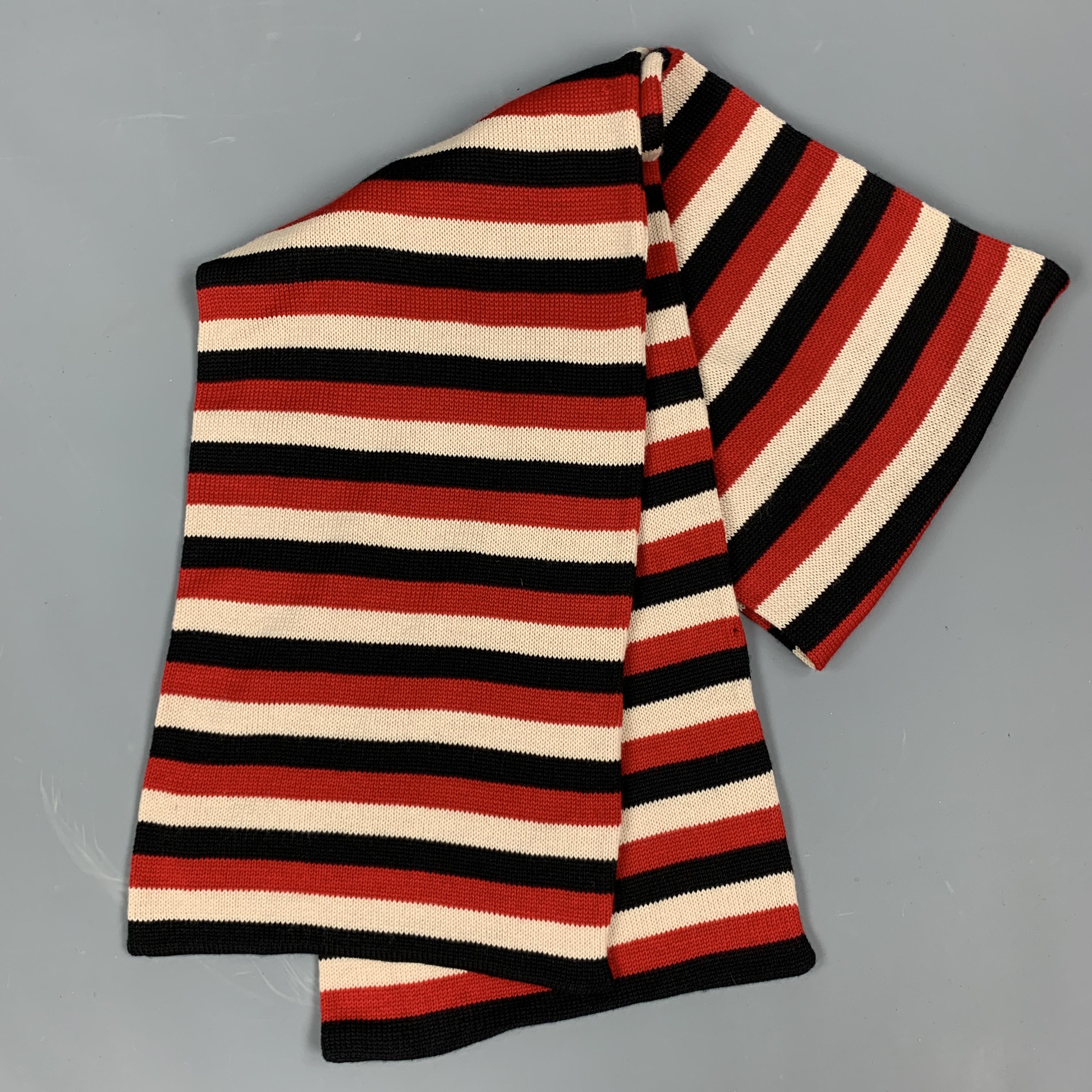 YOHJI YAMAMOTO POUR HOMME scarf comes in red, beige, and black striped wool knit in a long rectangular shape. Made in Japan.

Excellent Pre-Owned Condition.

76 x 12 in.