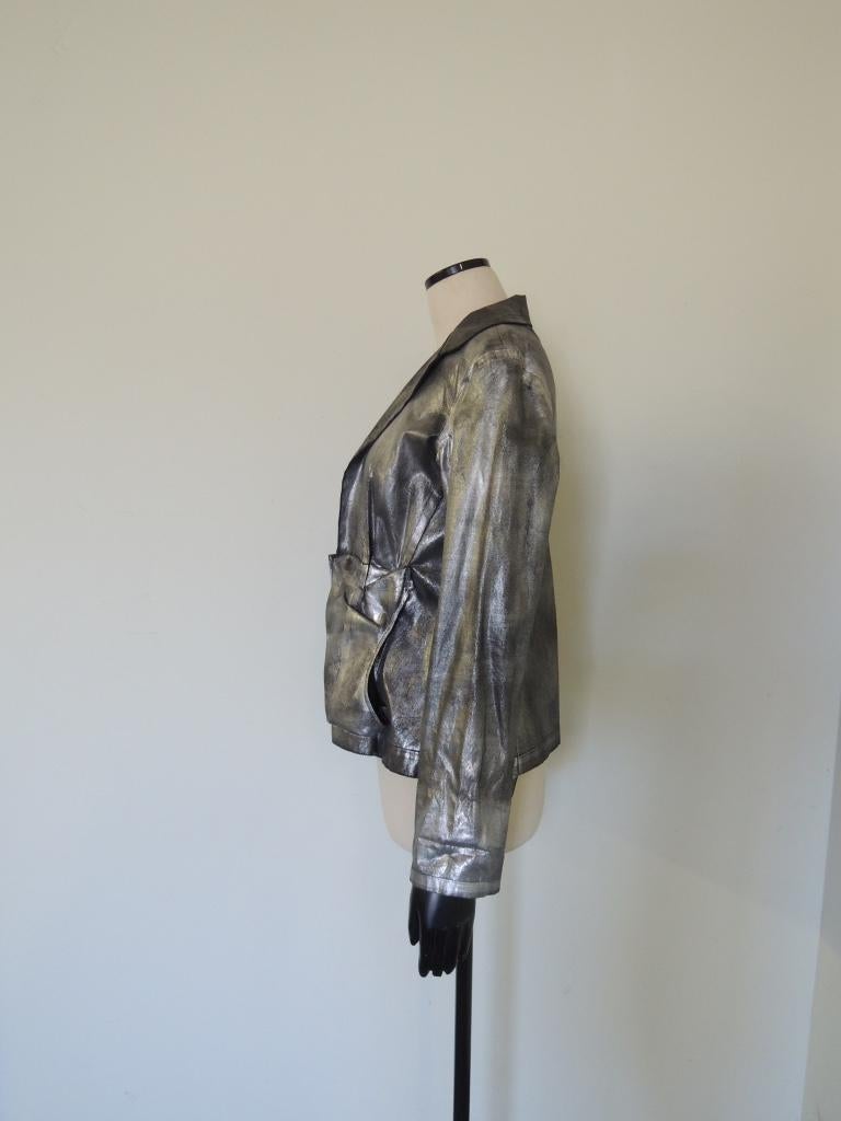 This is an open-front Yohji Yamamoto jacket in a metallic silver color. It has an unevenness and 