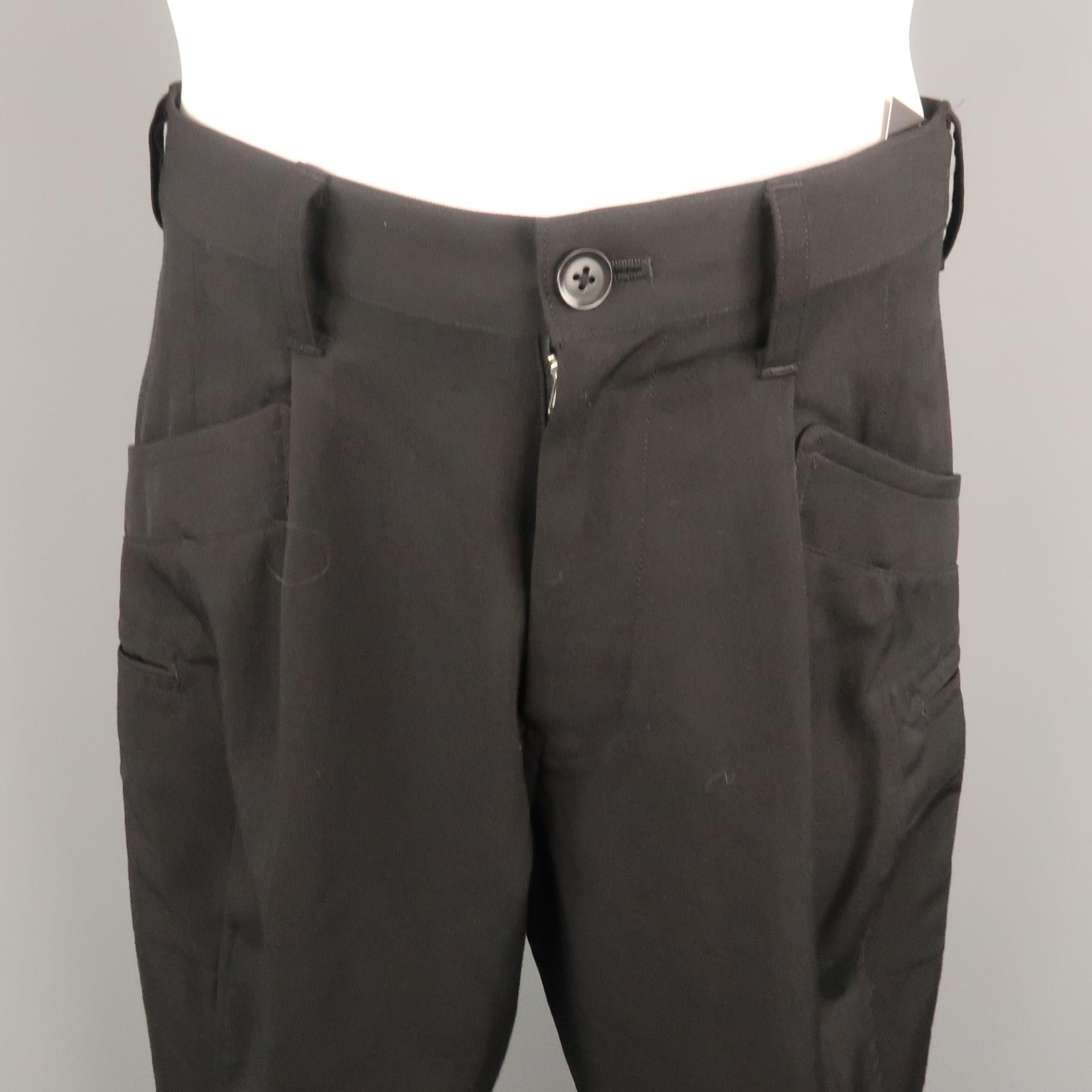YOHJI YAMAMOTO casual pant comes in a black wool featuring side leg pocket details. Made in Japan.

Excellent Pre-Owned Condition.
Marked: JP 2 

Measurements:

Waist: 32 in. 
Rise: 12.5 in. 
Inseam: 28 in. 