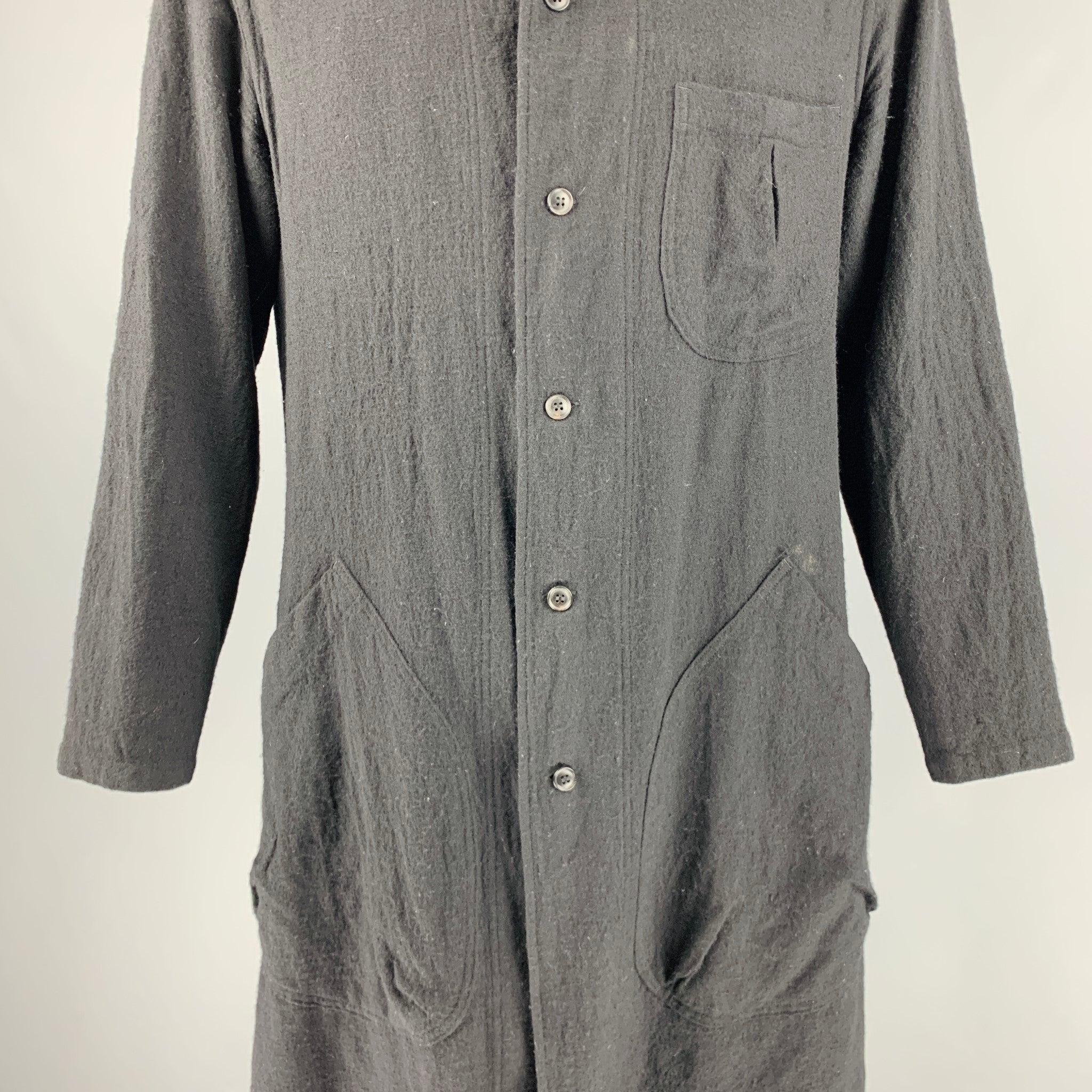 YOHJI YAMAMOTO PRODUCE coat
in a black wool fabric featuring white contrast stitching on collar and sleeves, patch pockets, and a button closure. Made in Japan.Very Good Pre-Owned Condition. Moderate signs of wear. 

Marked:   3 

Measurements: 
