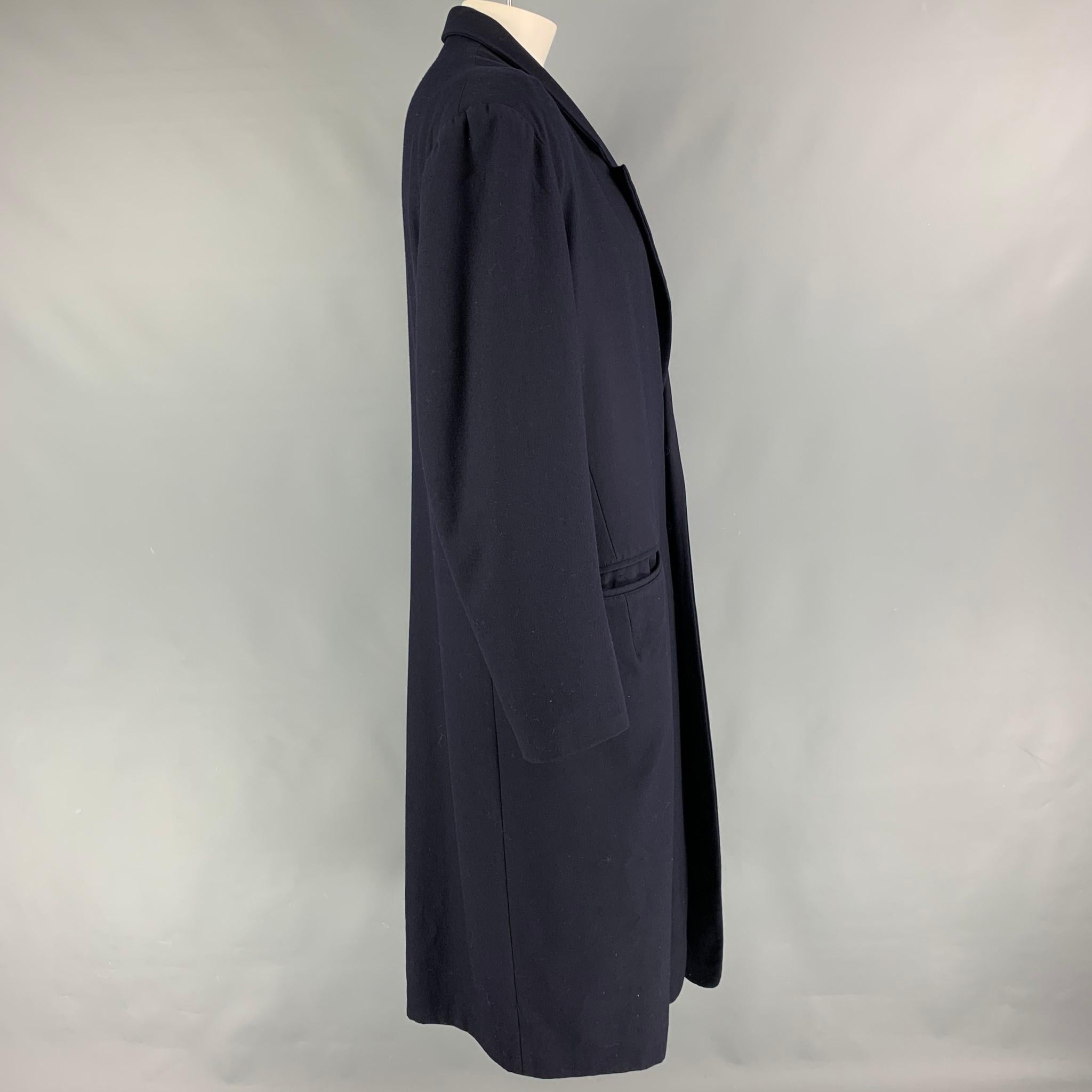 YOHJI YAMAMOTO coat comes in a navy wool with a full liner featuring a peak lapel, oversized fit, slit pockets, and a three button closure. Made in Japan. 
 

Very Good Pre-Owned Condition.
Marked: S

Measurements:

Shoulder: 22 in.
Chest: 50