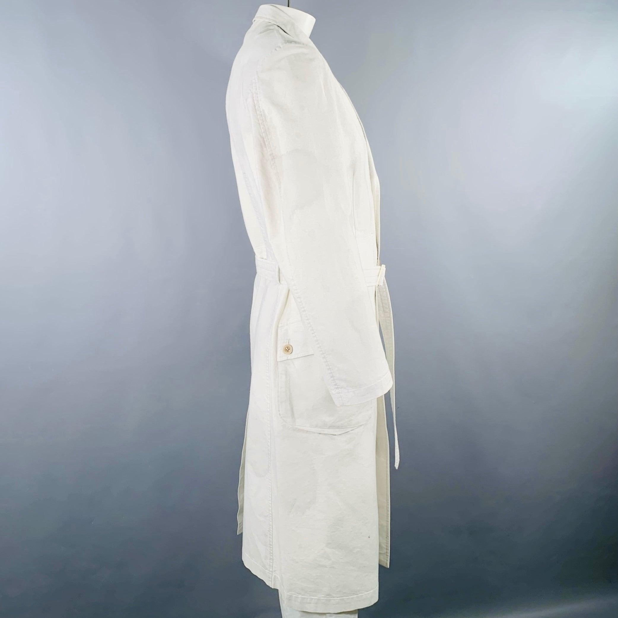 YOHJI YAMAMOTO coat
in a light grey cotton woven fabric featuring two large buttoned pockets, and button closure with belt. Made in Japan.Very Good Pre-Owned Condition. Moderate marks, as is. 

Marked:   JP 4 

Measurements: 
 
Shoulder: 18.5 inches